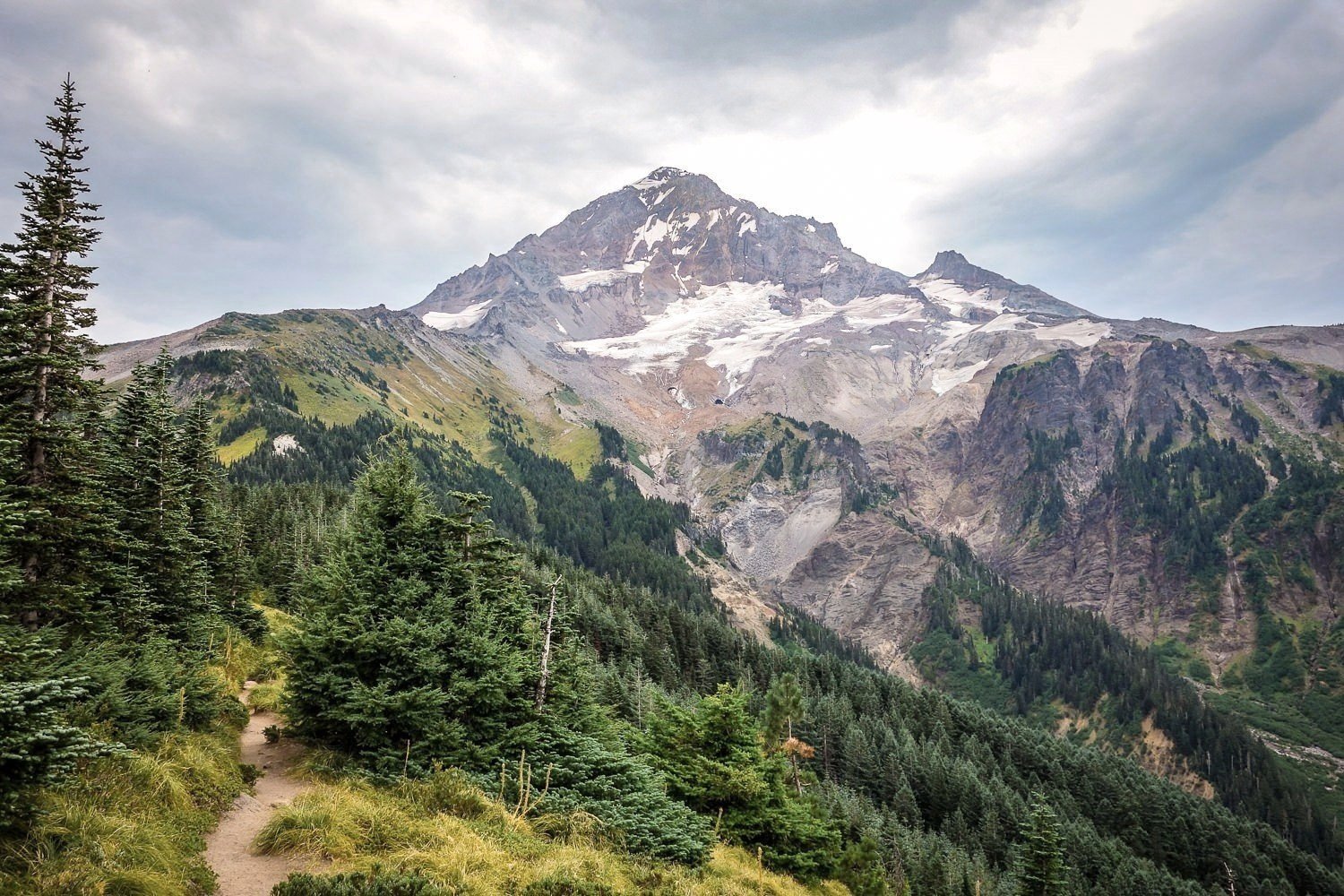 southwest view of mt. hood showing the undulating ridges and rock feature that surround the peak. 