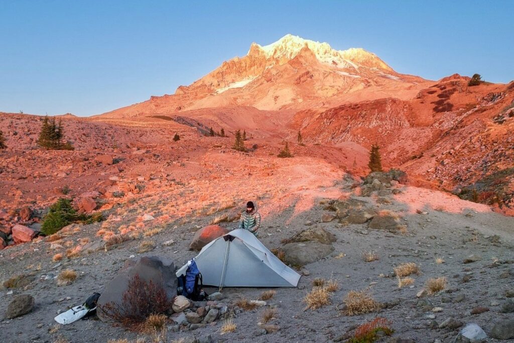 campers at their tent site during alpenglow on the flanks of mt. hood