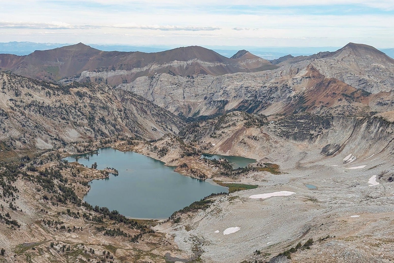 overlooking glacier lake from the summit of eagle cap. The lake is surrounded by a granite 