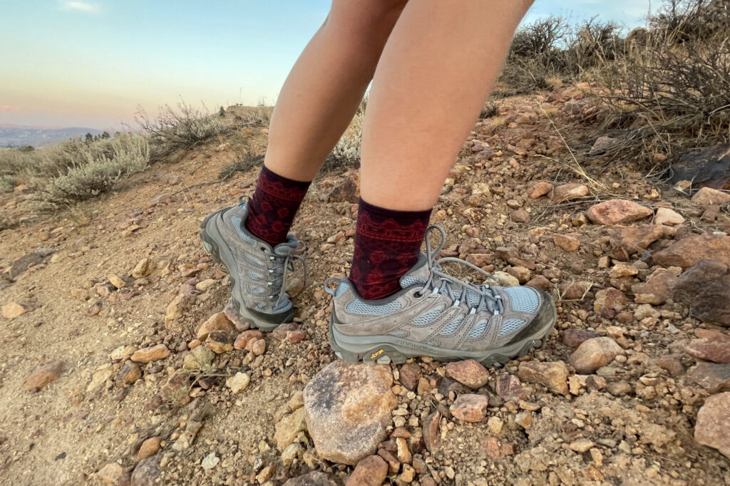 hiker's feet wearing the merrell moab 3 on loose gravel