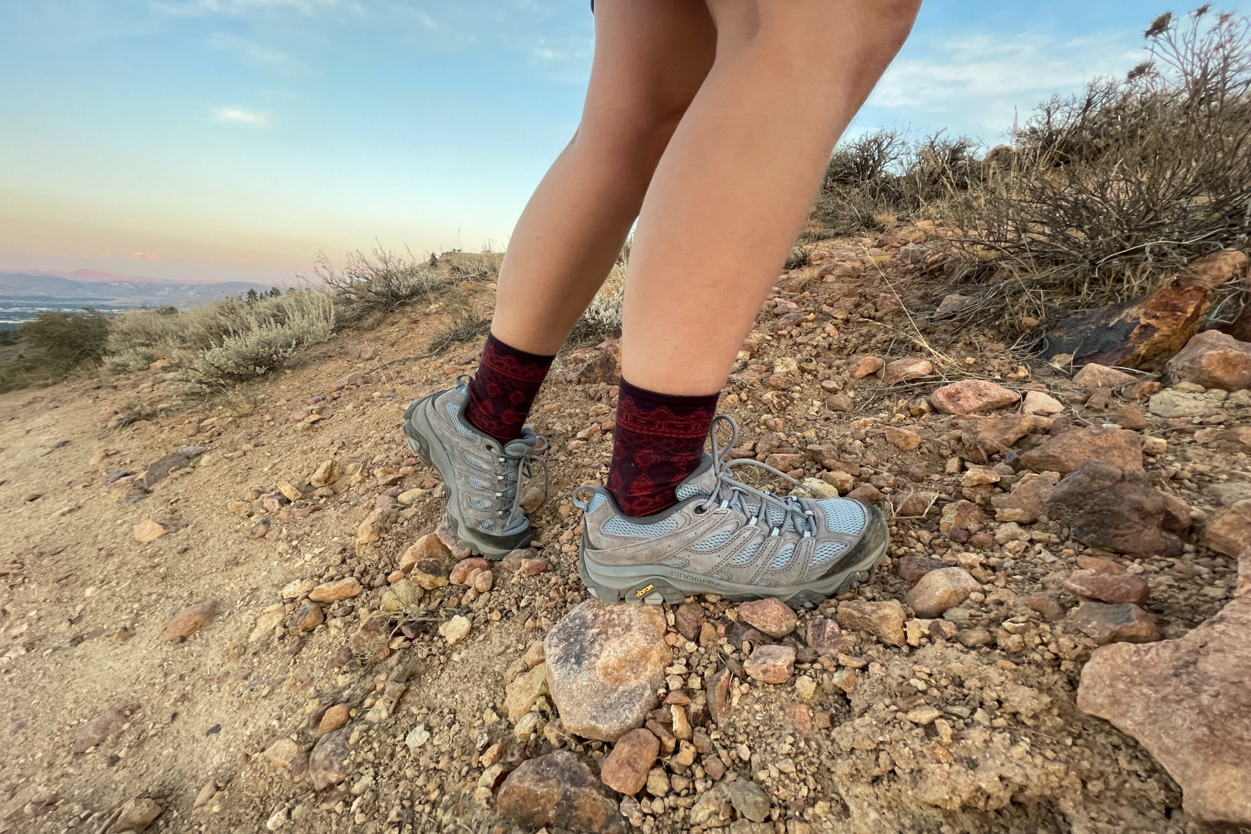 hiker's feet wearing the merrell moab 3 on loose gravel