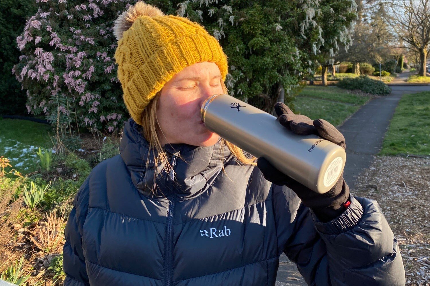 https://www.cleverhiker.com/wp-content/uploads/2020/05/Hydro-Flask-Lightweight-Trail-Series-Wide-Mouth-Vacuum-Insulated-Water-Bottle-on-a-walk-on-a-chilly-day.jpeg
