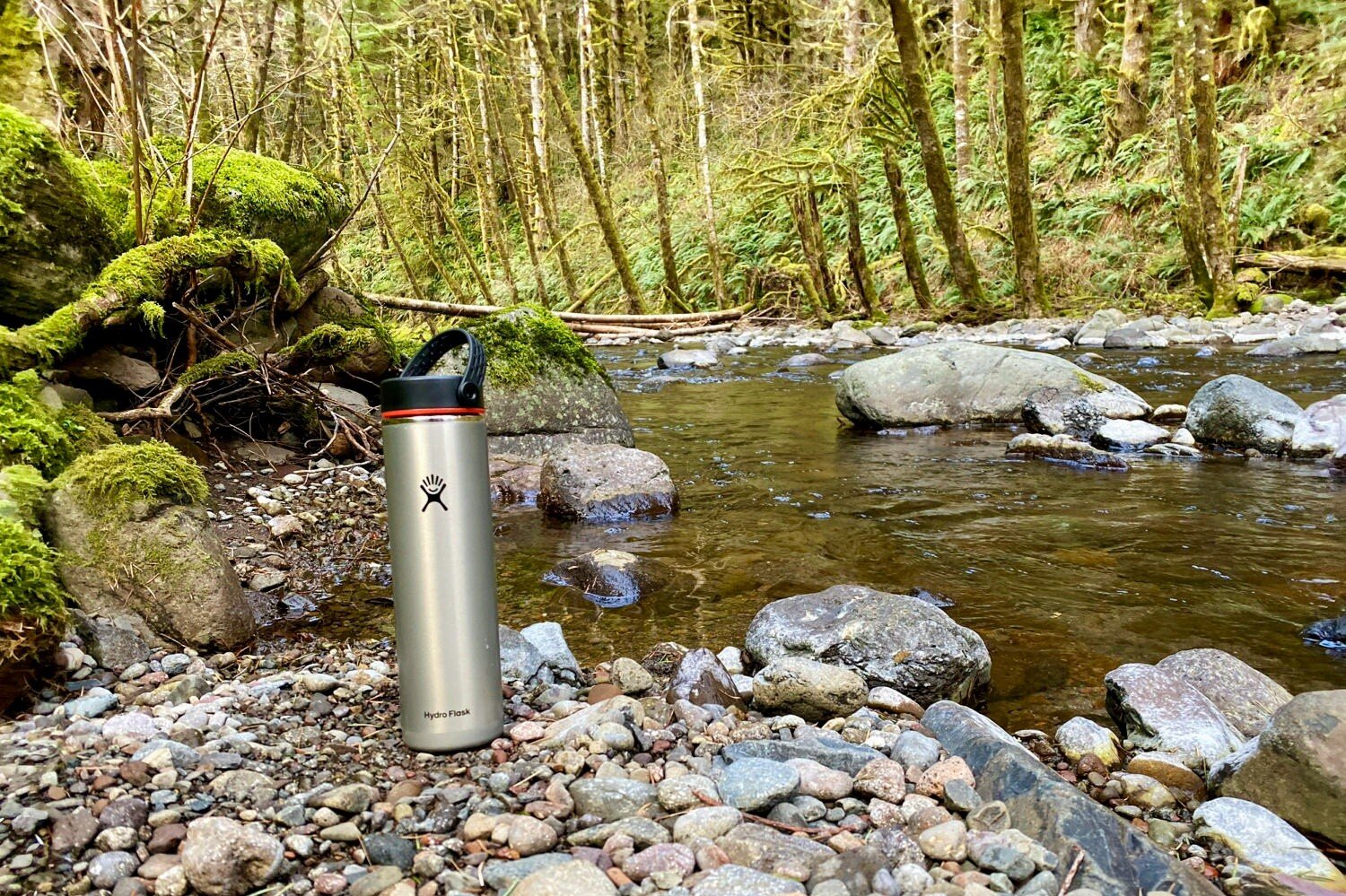 https://www.cleverhiker.com/wp-content/uploads/2020/05/Taking-the-Hydro-Flask-Lightweight-Trail-Series-Wide-Mouth-Vacuum-Insulated-Water-Bottle-on-a-dayhike-along-a-creek.jpeg