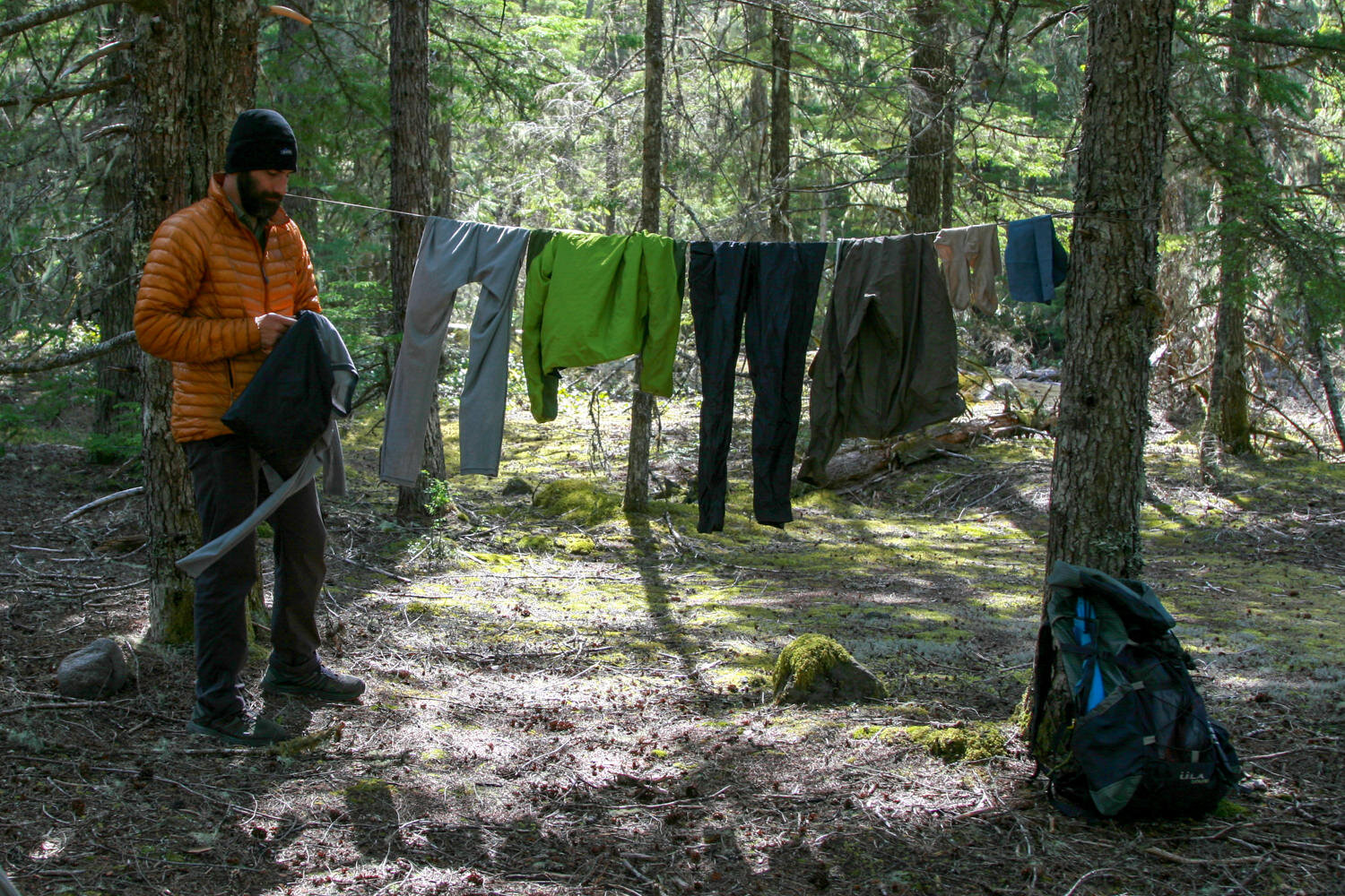 https://www.cleverhiker.com/wp-content/uploads/2020/11/a-backpacking-hanging-clothes-on-a-clothesline.jpeg