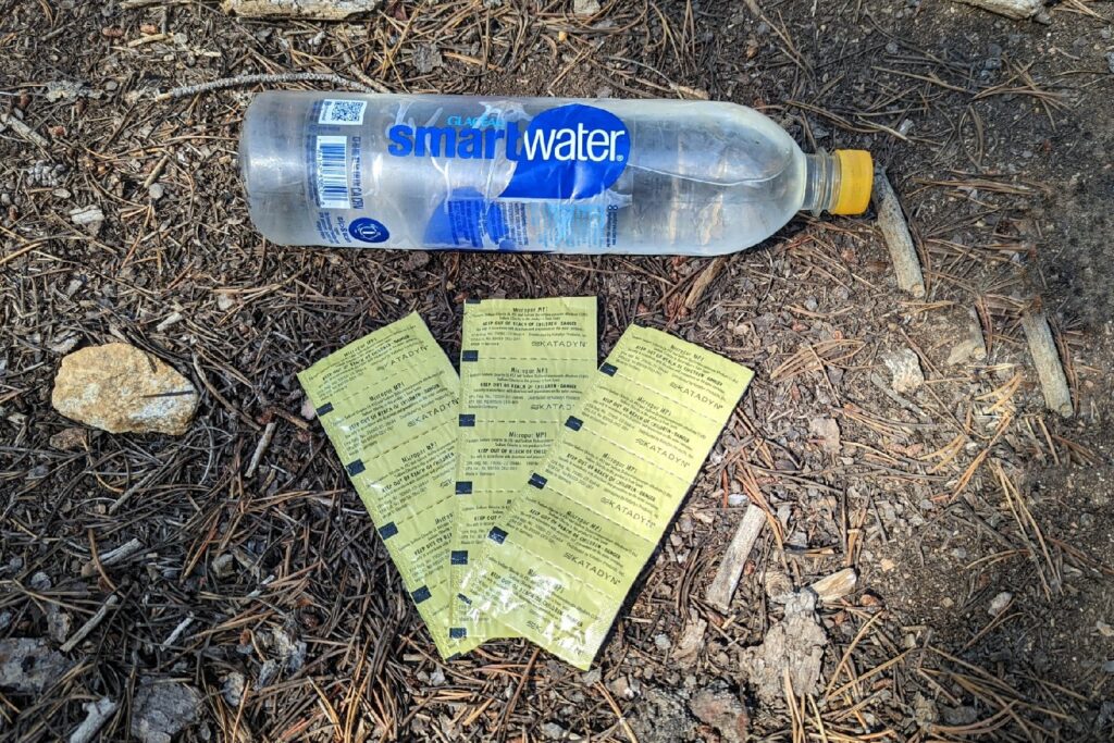 micropur tablets in their sleeve package with a smartwater bottle on the ground