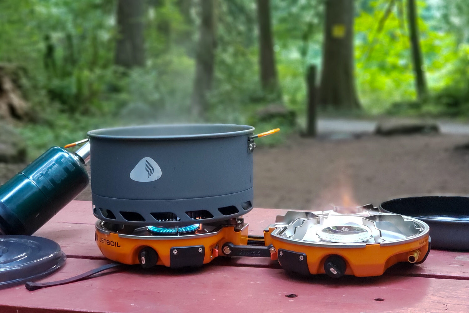 https://www.cleverhiker.com/wp-content/uploads/2023/08/The-Jetboil-Genesis-Basecamp-System-being-used-to-boil-water-in-a-campsite.jpeg