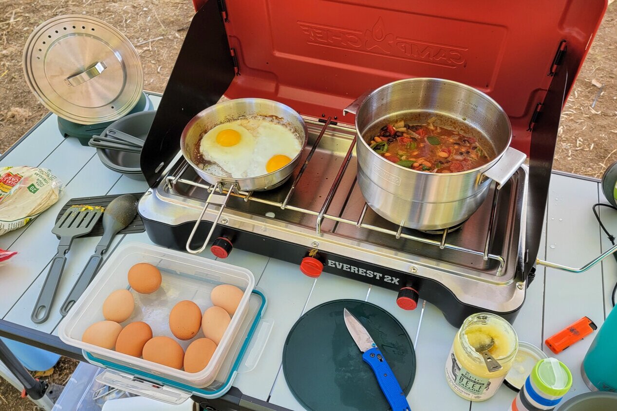 https://www.cleverhiker.com/wp-content/uploads/2023/08/The-Stanley-Adventure-Base-Camp-Cookset-4-being-used-to-cook-beans-and-eggs-in-camp.jpeg