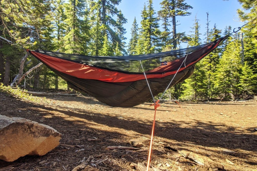 The Warbonnet Blackbird hammock set up in a sunny opening of a campground