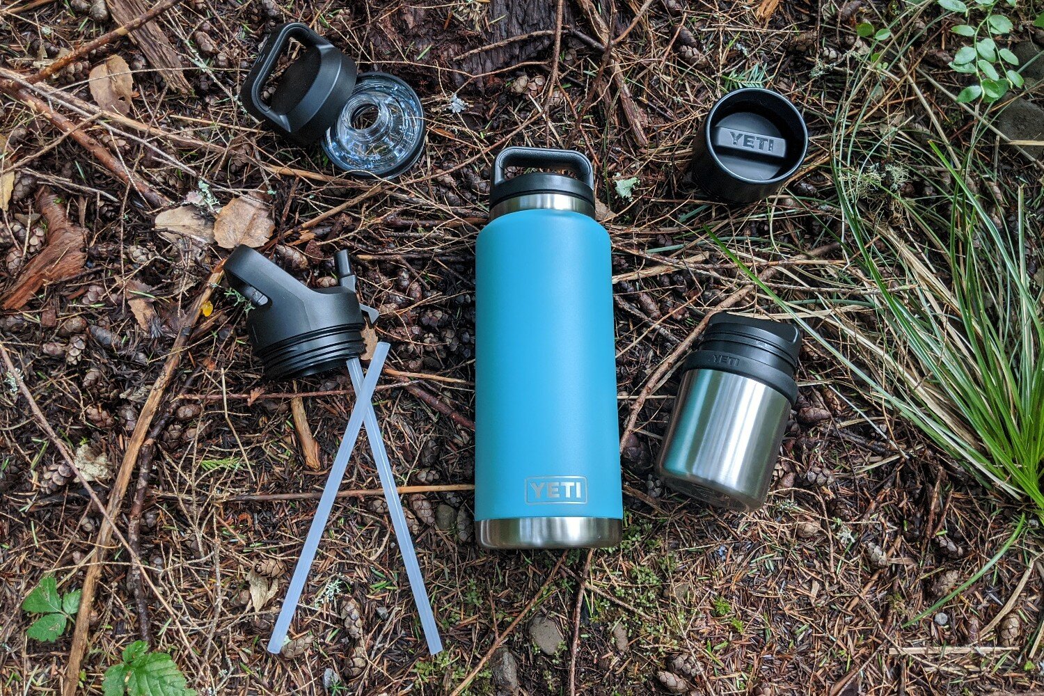 https://www.cleverhiker.com/wp-content/uploads/2023/08/The-Yeti-Rambler-Vacuum-Bottle-36-oz-and-its-accessories-laid-out-on-the-forest-floor.jpeg