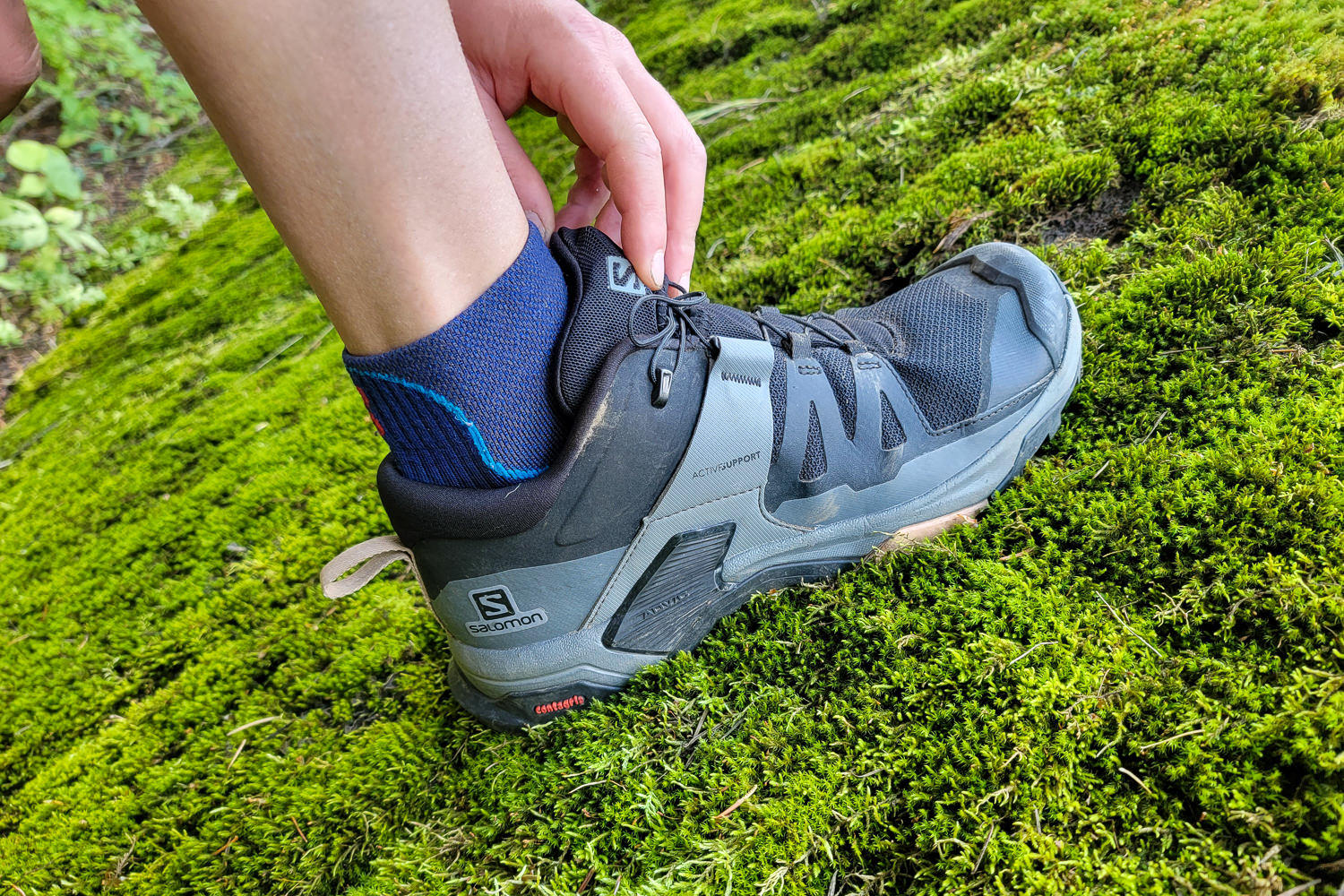 Closeup of a hiker securing the quicklace on the Salomon X Ultra 4 GTX shoe