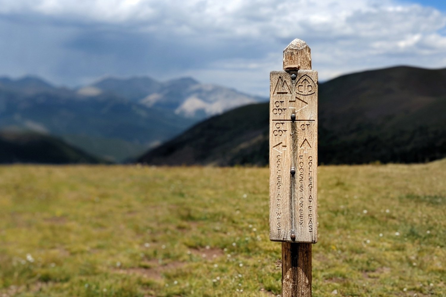 wooden trail sign marking the collegiate range and the colorado trail and the continental divide trail