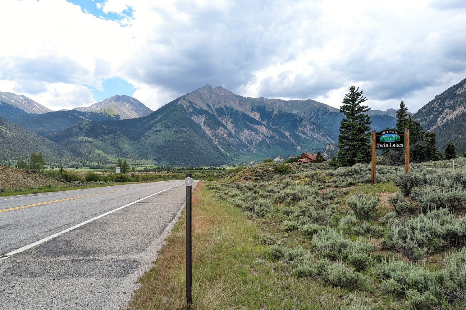 road leading to the mountains on a sunny yet cloudy day