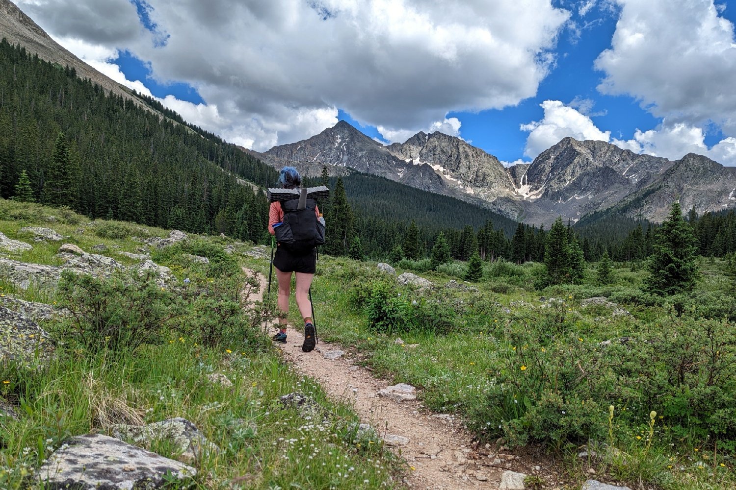 backpacker on the colorado trail below mountains