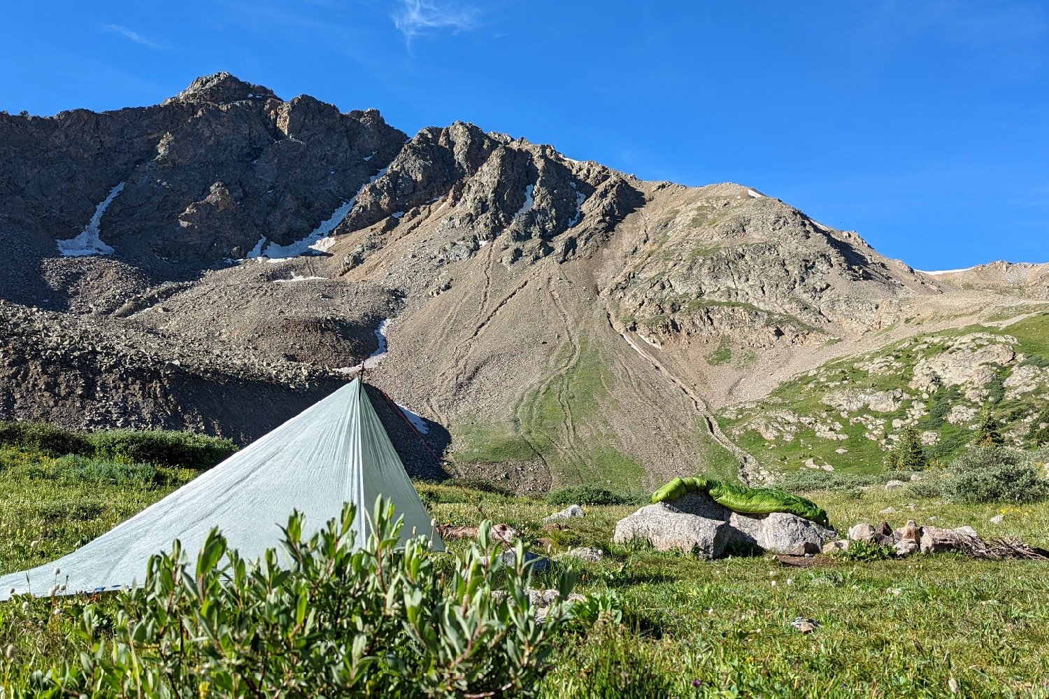 lightweight tarp pitched below a ridge on the colorado trail