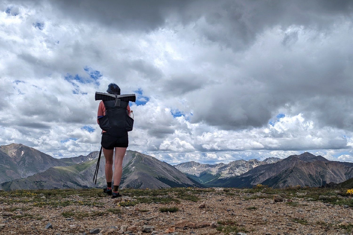 backpacker on the colorado trail in the high alpine with clouds overhead