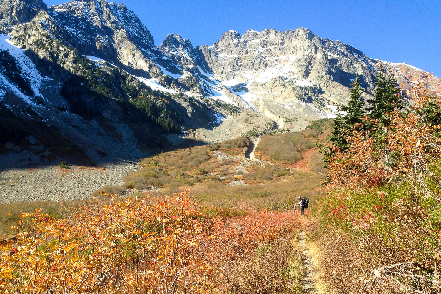 Mountain landscape in the fall with a thru-hiker hiking on the trail