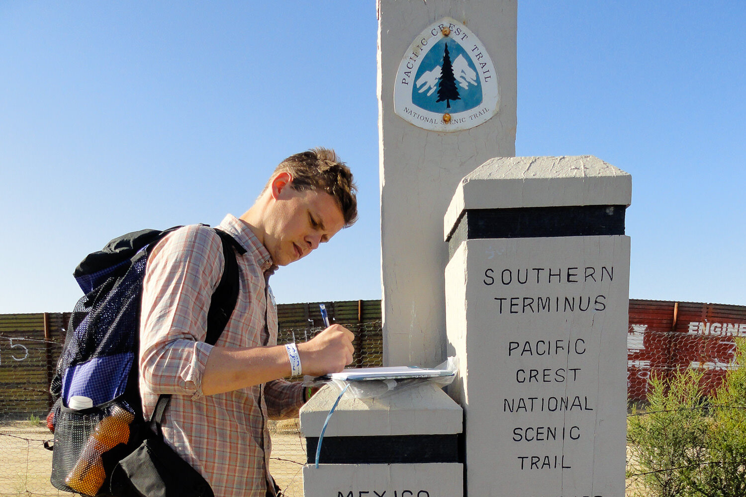 Thru-hiker signs the log book at the southern terminus of the Pacific Crest Trail