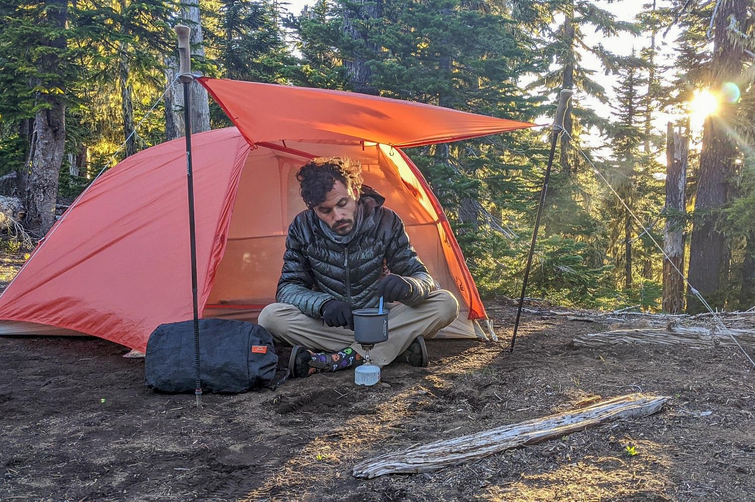 backpacker using their jet boil next to their tent in the three sisters wilderness