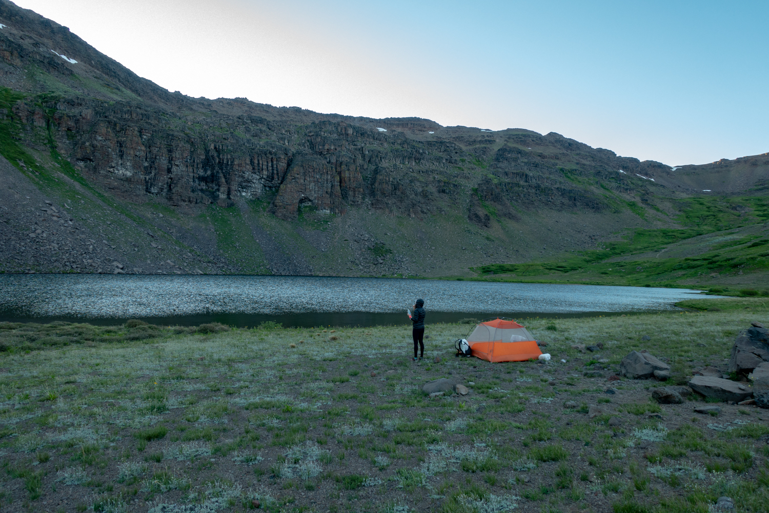 backpackers in the steens mountain setting up camp next to wildhorse lake