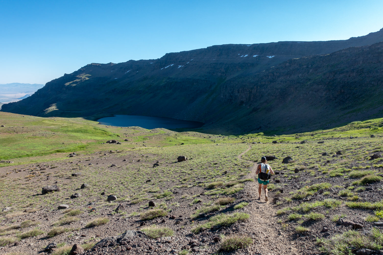 backpacker approaching wildhorse lake on steens mountain in oregon