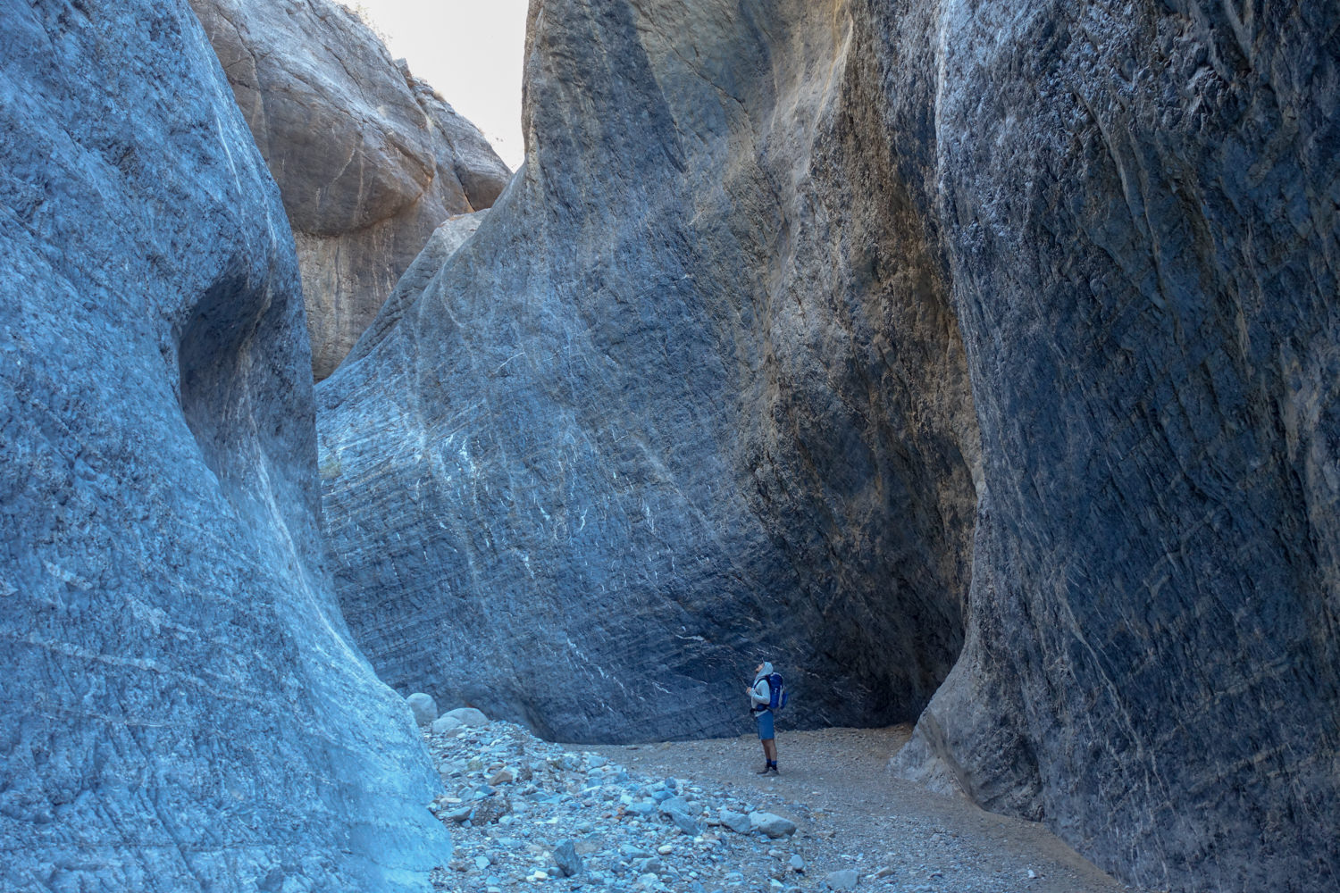 backpacker in a slot canyon on the cottonwood marble canyon loop in death valley