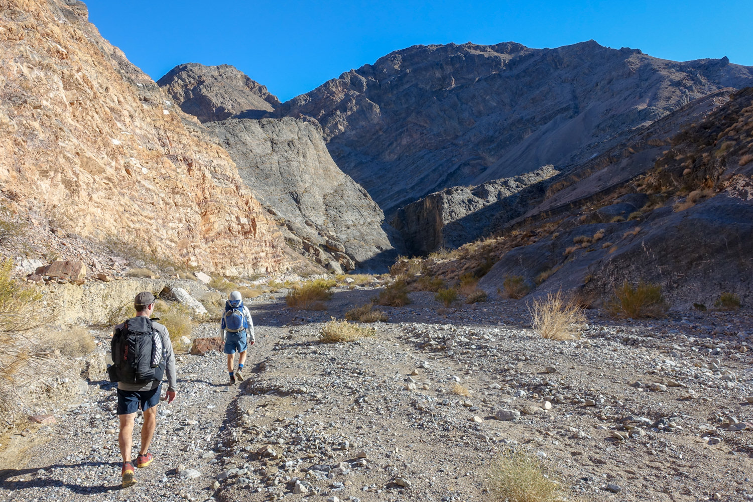 walking towards the shaded canyon and mountains in death valley