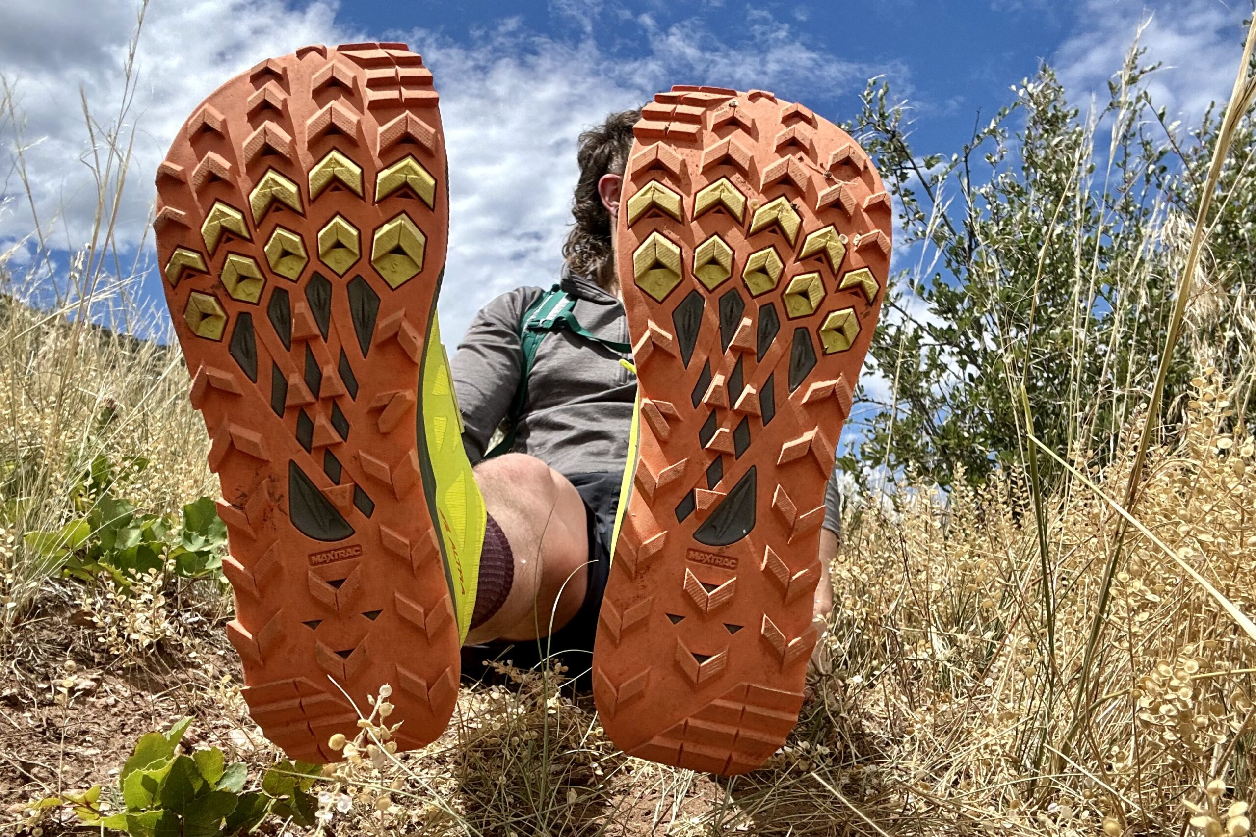 A close up of a pair of trail running shoe's tread pattern.