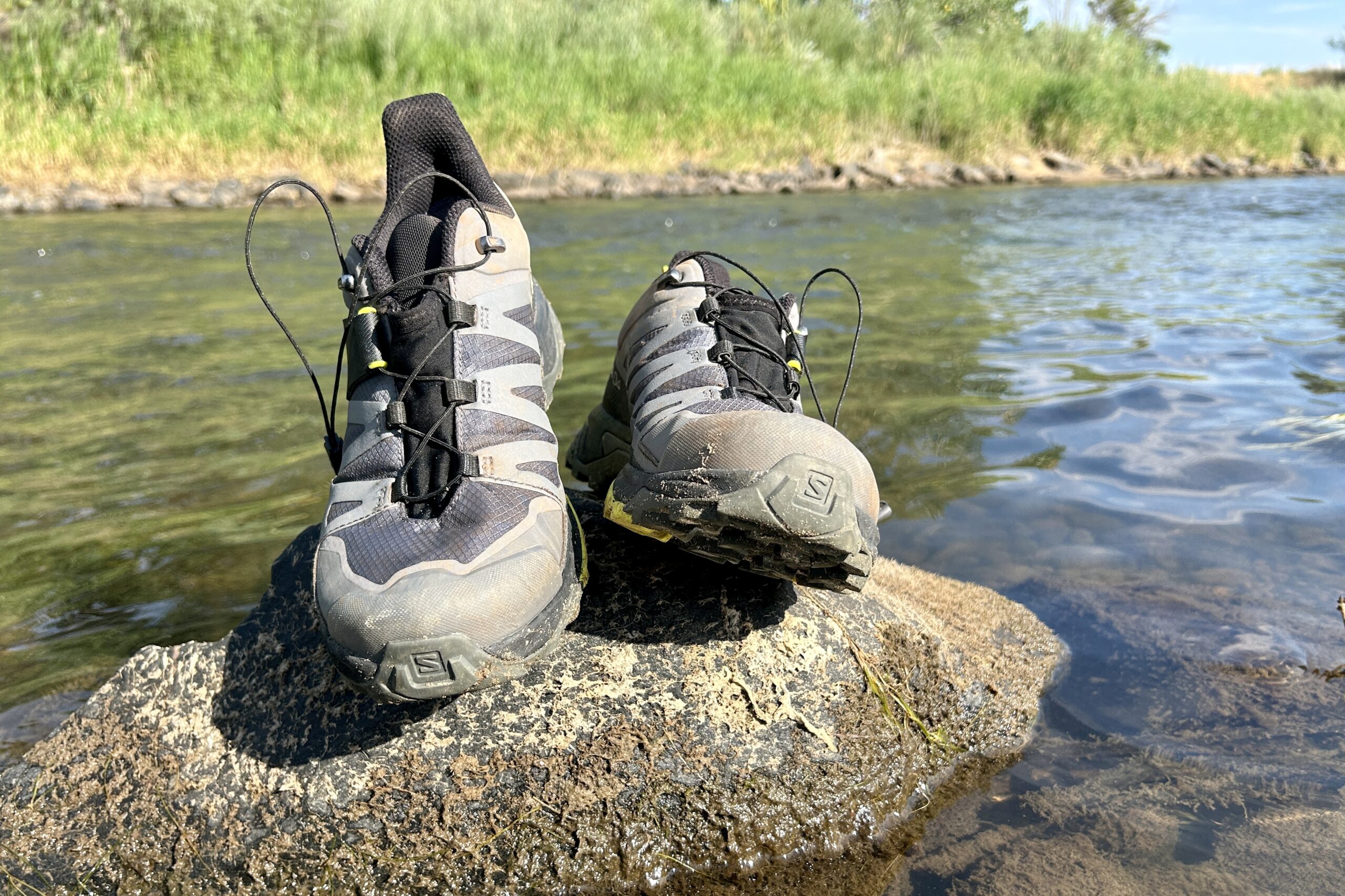 A close up shot of the Salomon Ultra GTX 4 hiking shoes from the front, posed on a rock.