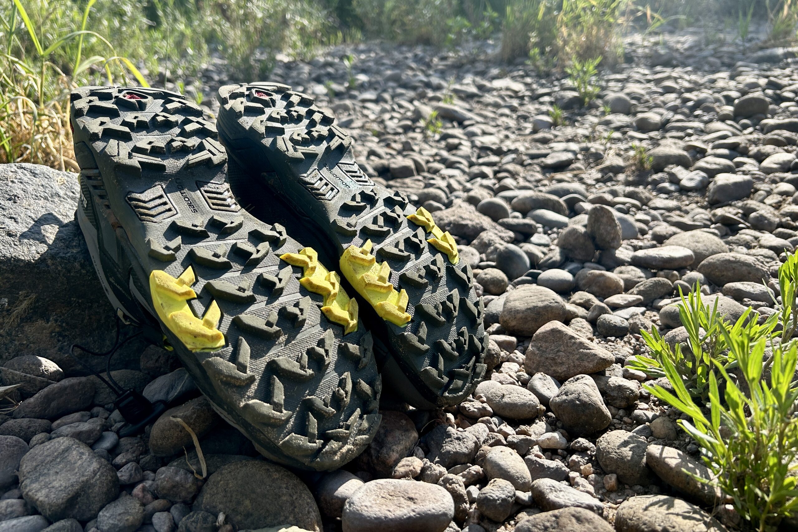 A close up shot of the Salomon Ultra GTX 4 hiking shoes turned upside down to show the beefy tread pattern.