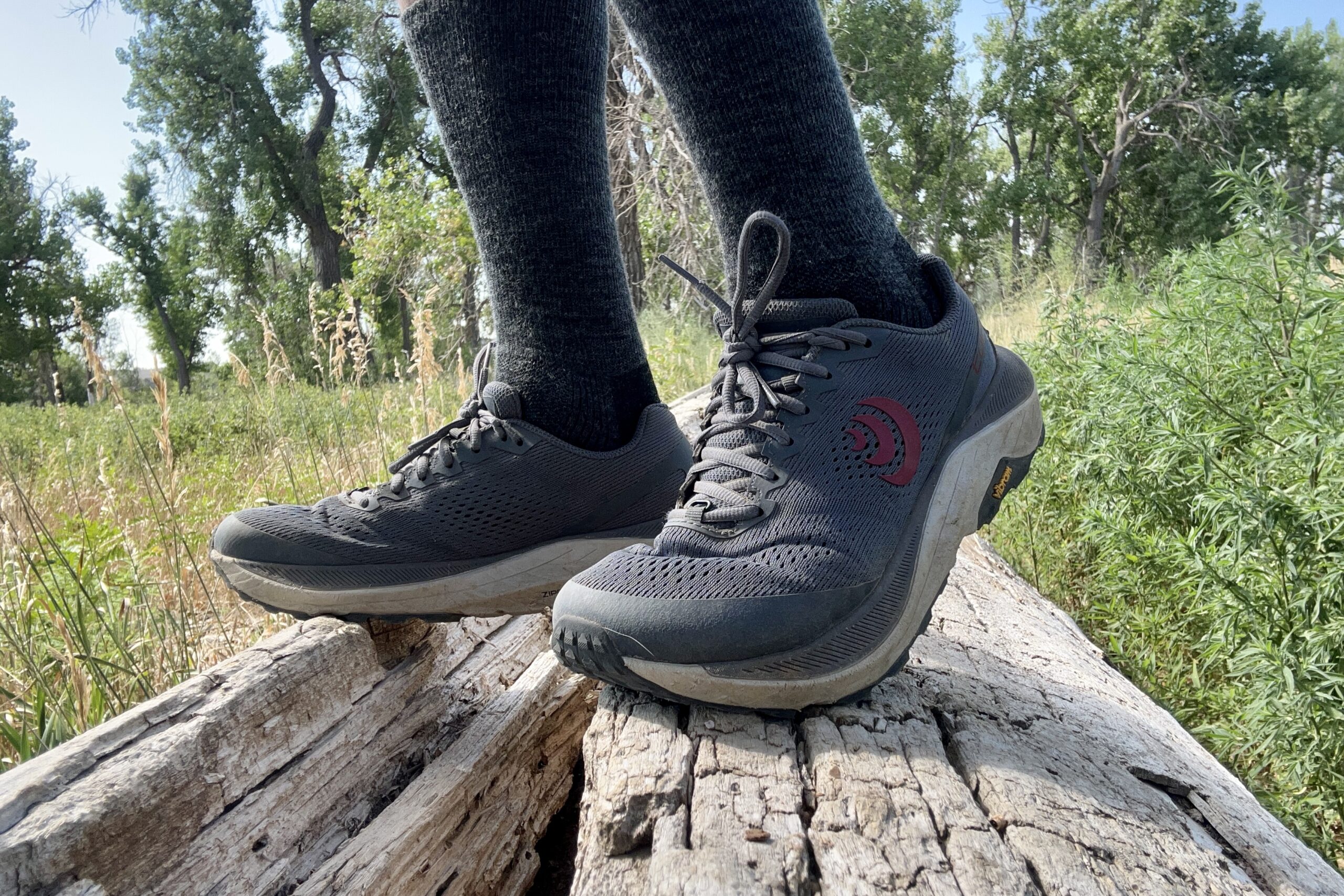 A close up shot of a man wearing the men's Topo Athletic Ultraventure 3 shoes.