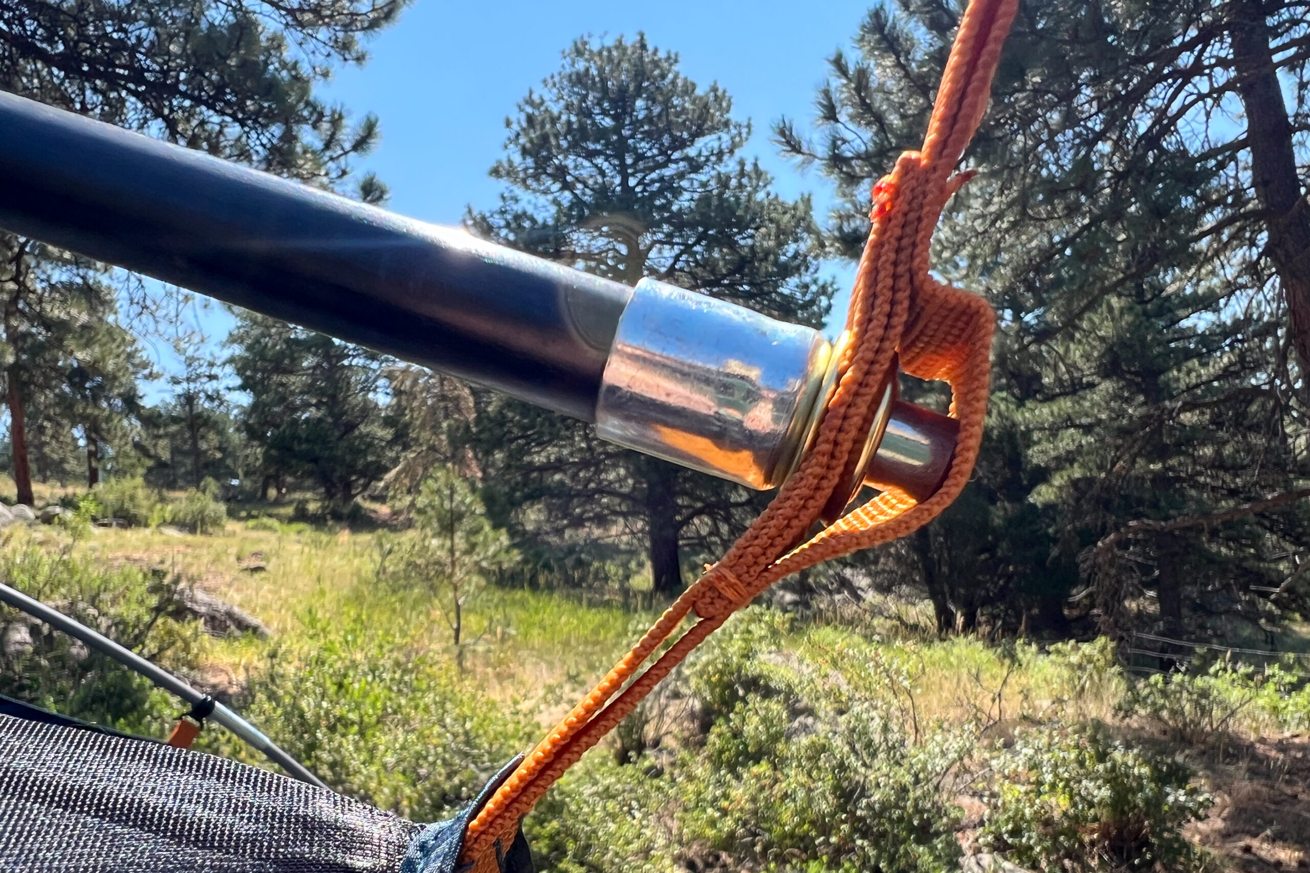 The image shows a tent pole placed in orange webbing.