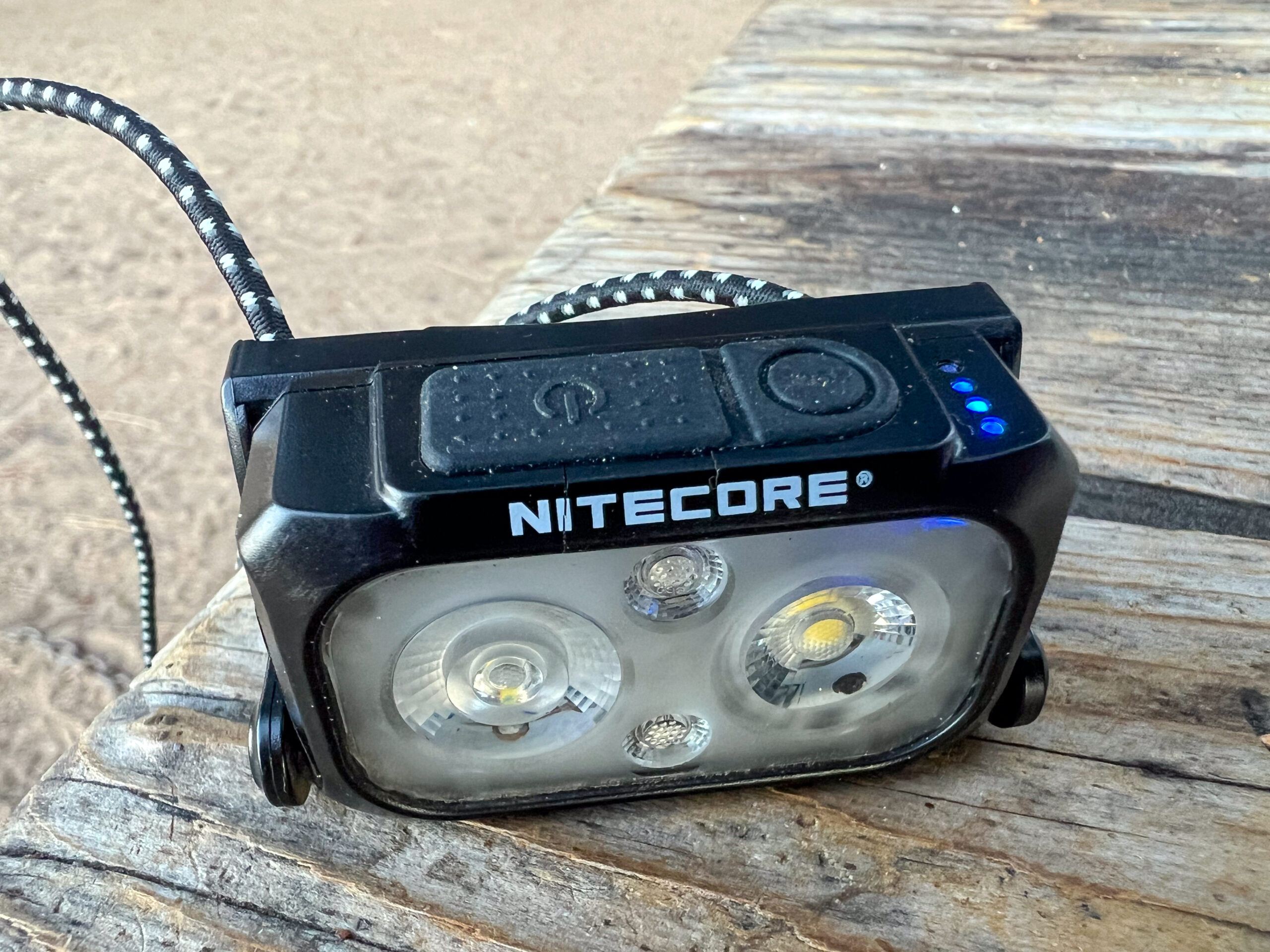 The image shows the top of the Nitecore NU25 UL headlamp with the battery life indicator illuminated.