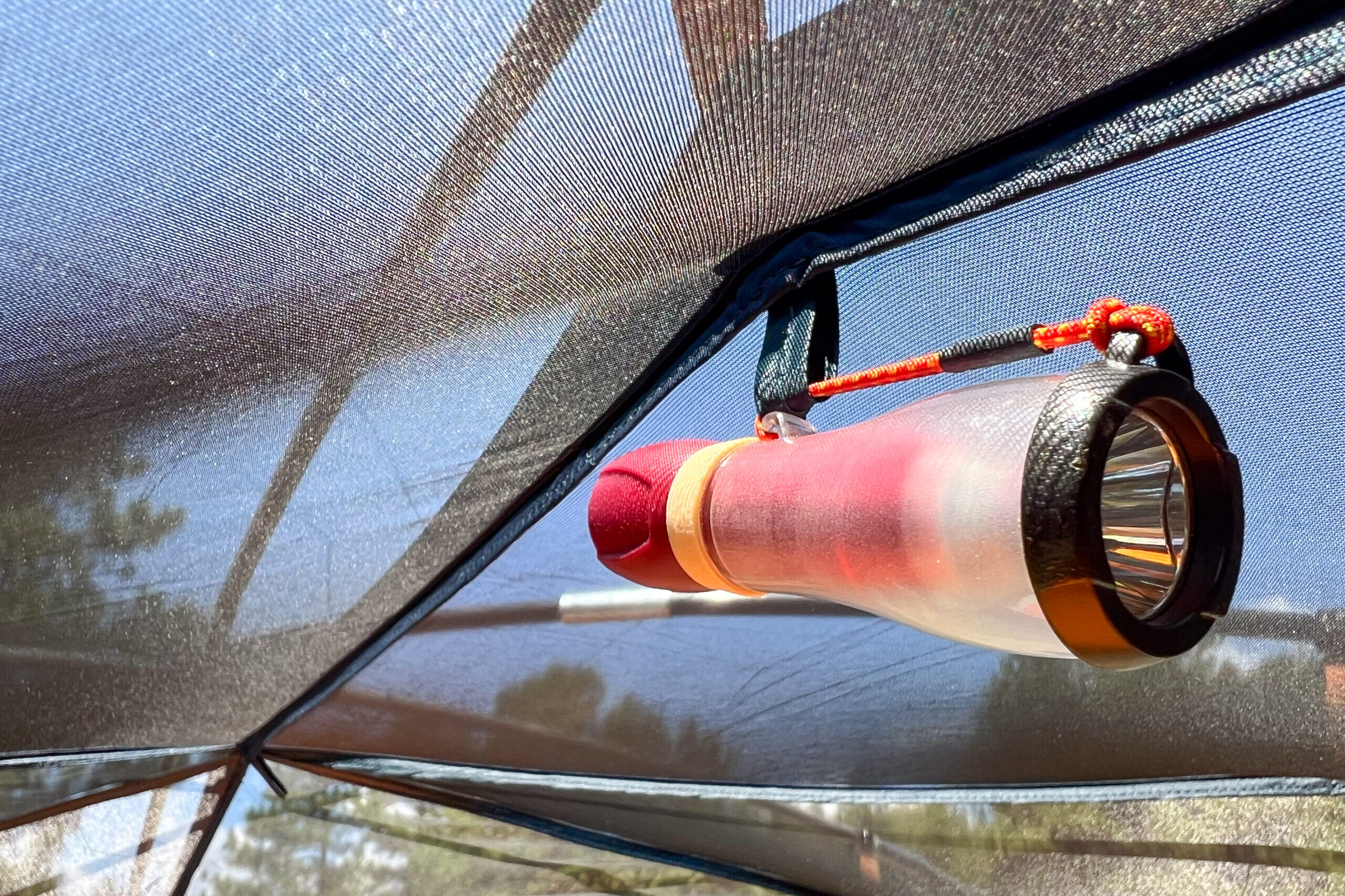 The image shows a small light hanging on the interior mesh ceiling of the Kelty Wireless 6 tent.