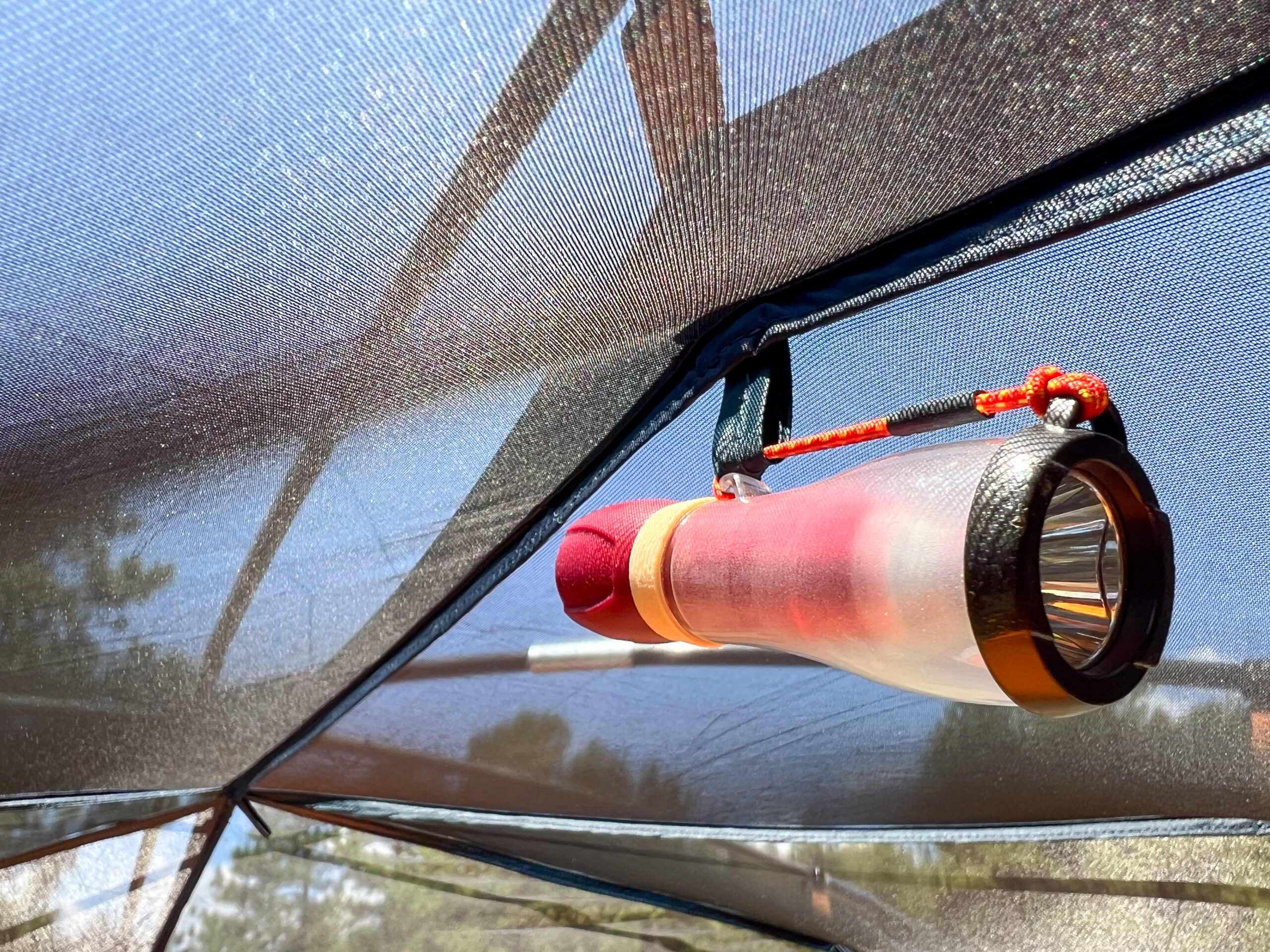 The image shows a small light hanging on the interior mesh ceiling of the Kelty Wireless 6 tent.