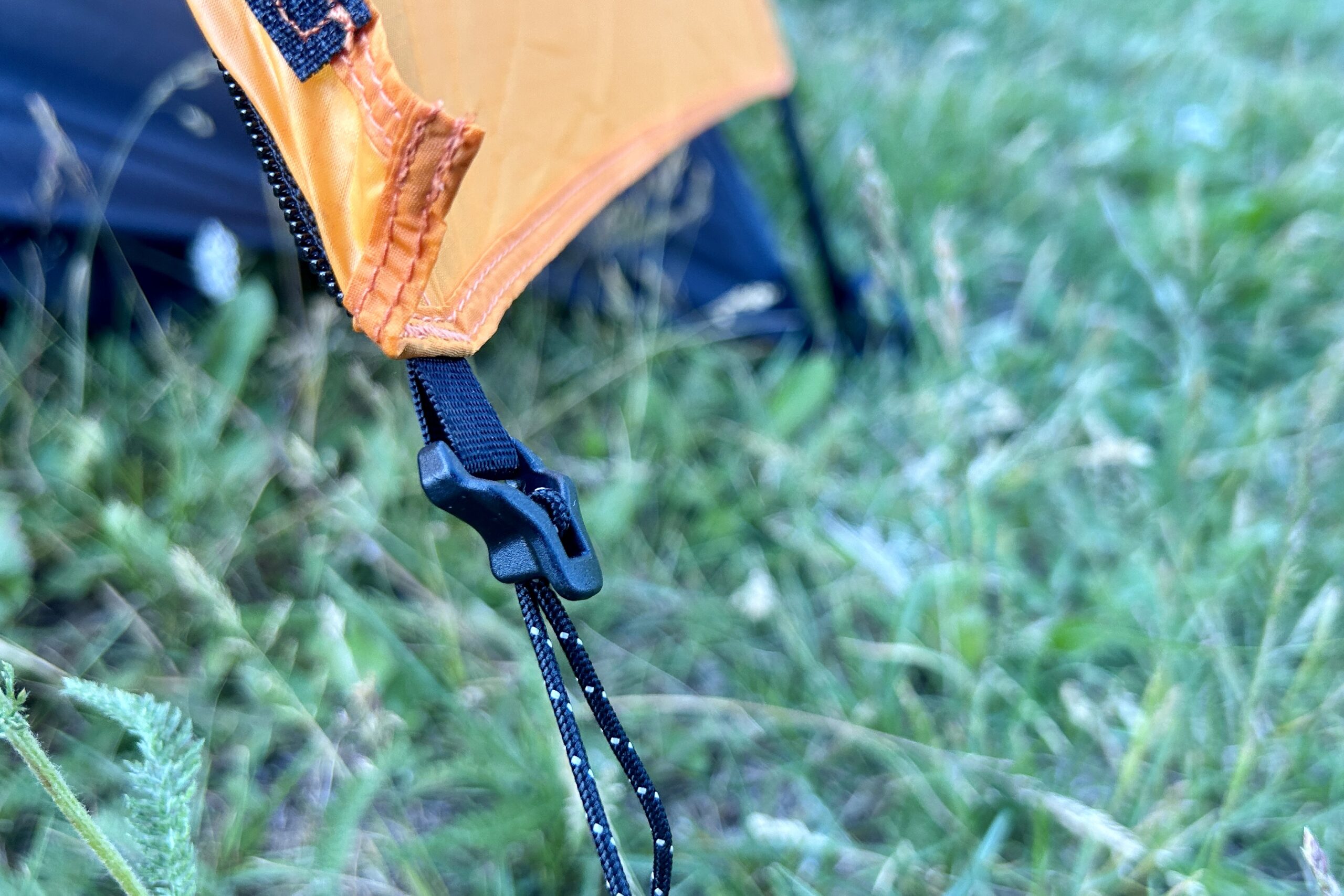 Closeup of a rainfly tightening mechanism at the door entrance.