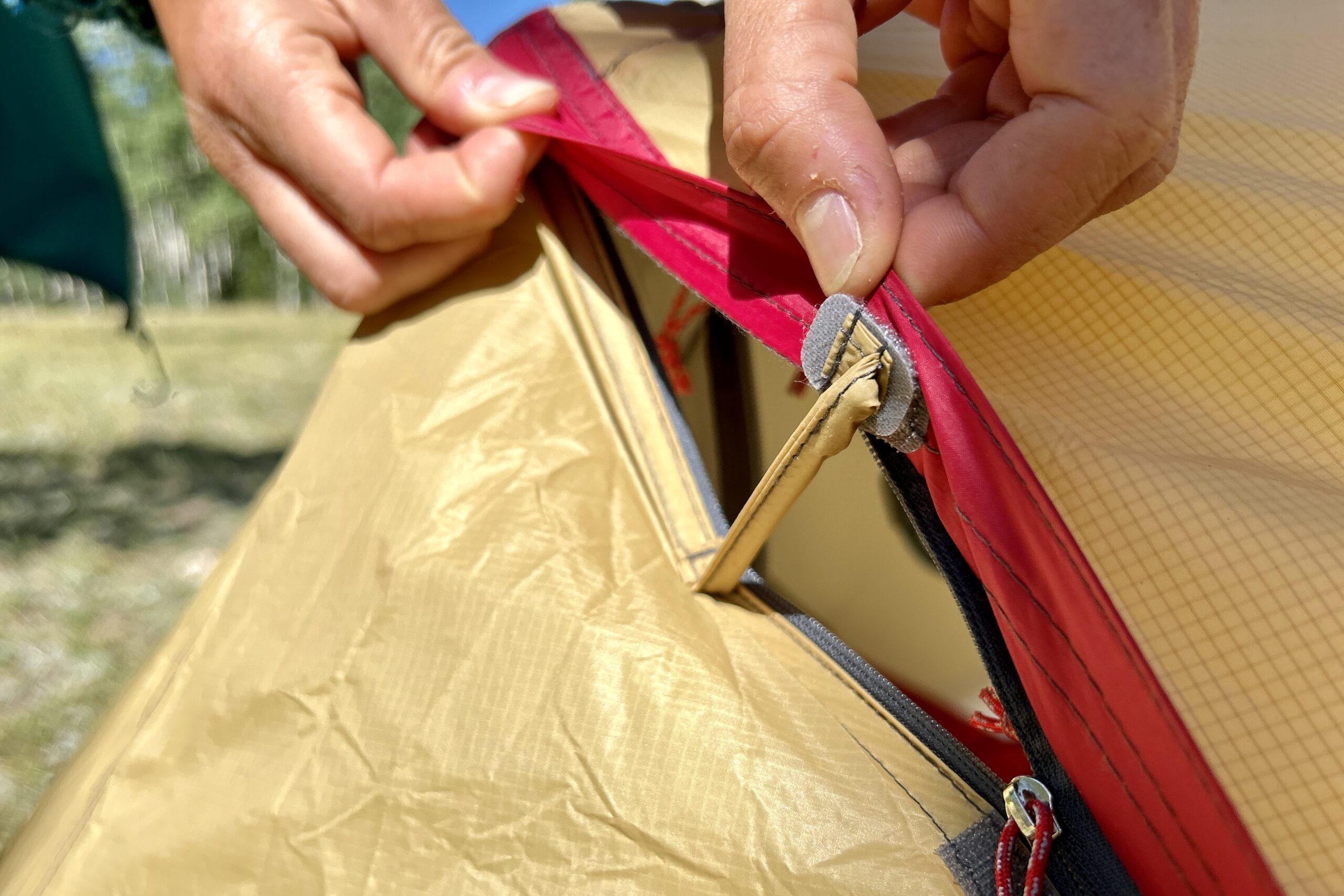 A closeup of a tent rainfly ventilation kickstand.