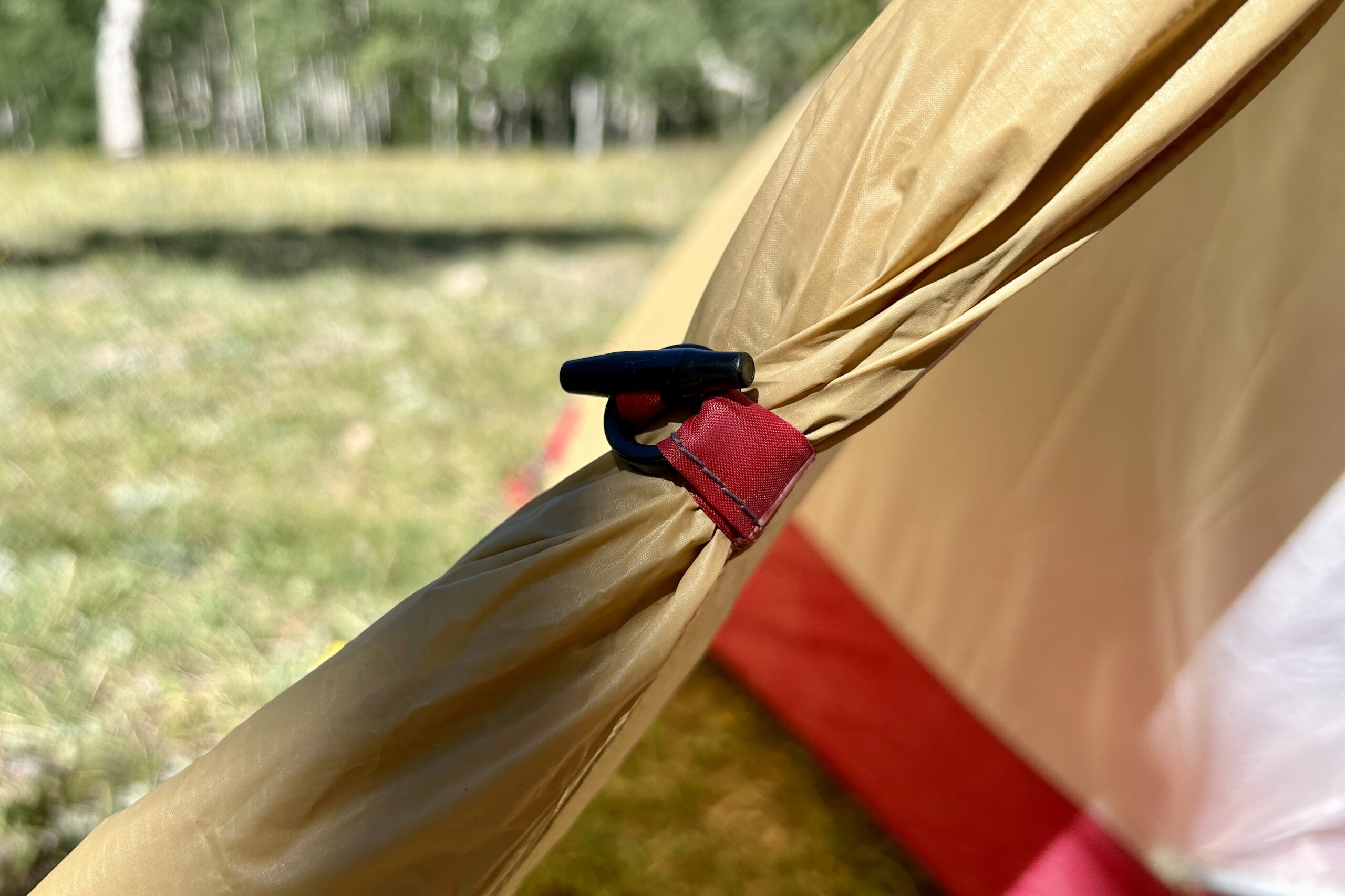 A closeup of a tent rainfly tieback.