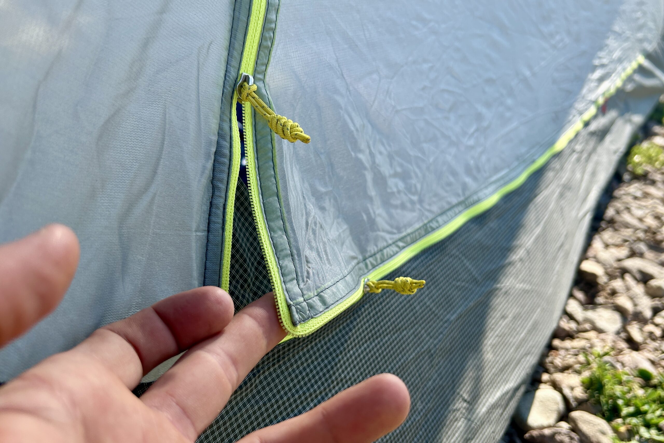 A closeup of the zippers of a tent.