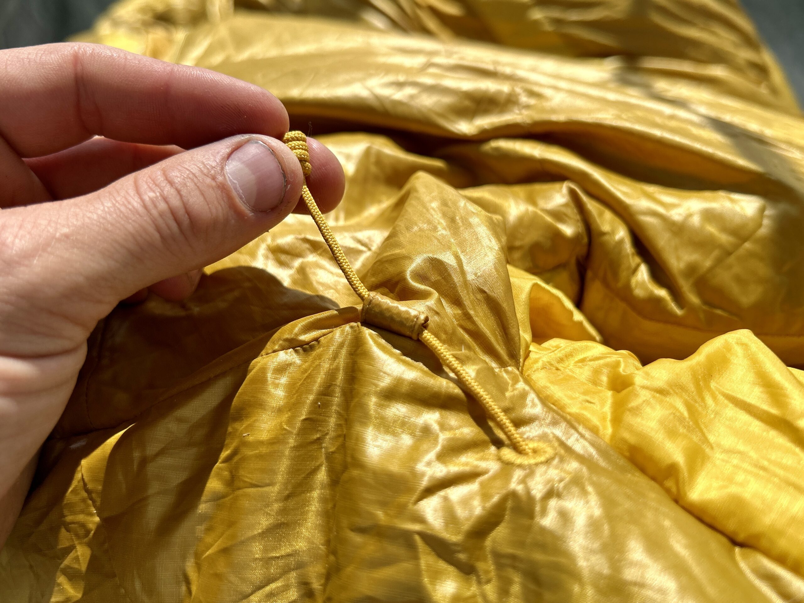 A close up of the cinching mechanism on the hood of a sleeping bag.