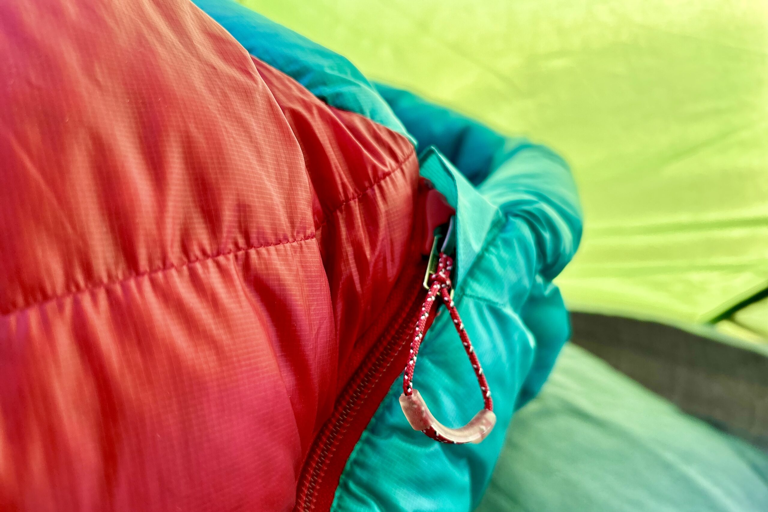 An up-close image of a zipper pull on a sleeping bag.