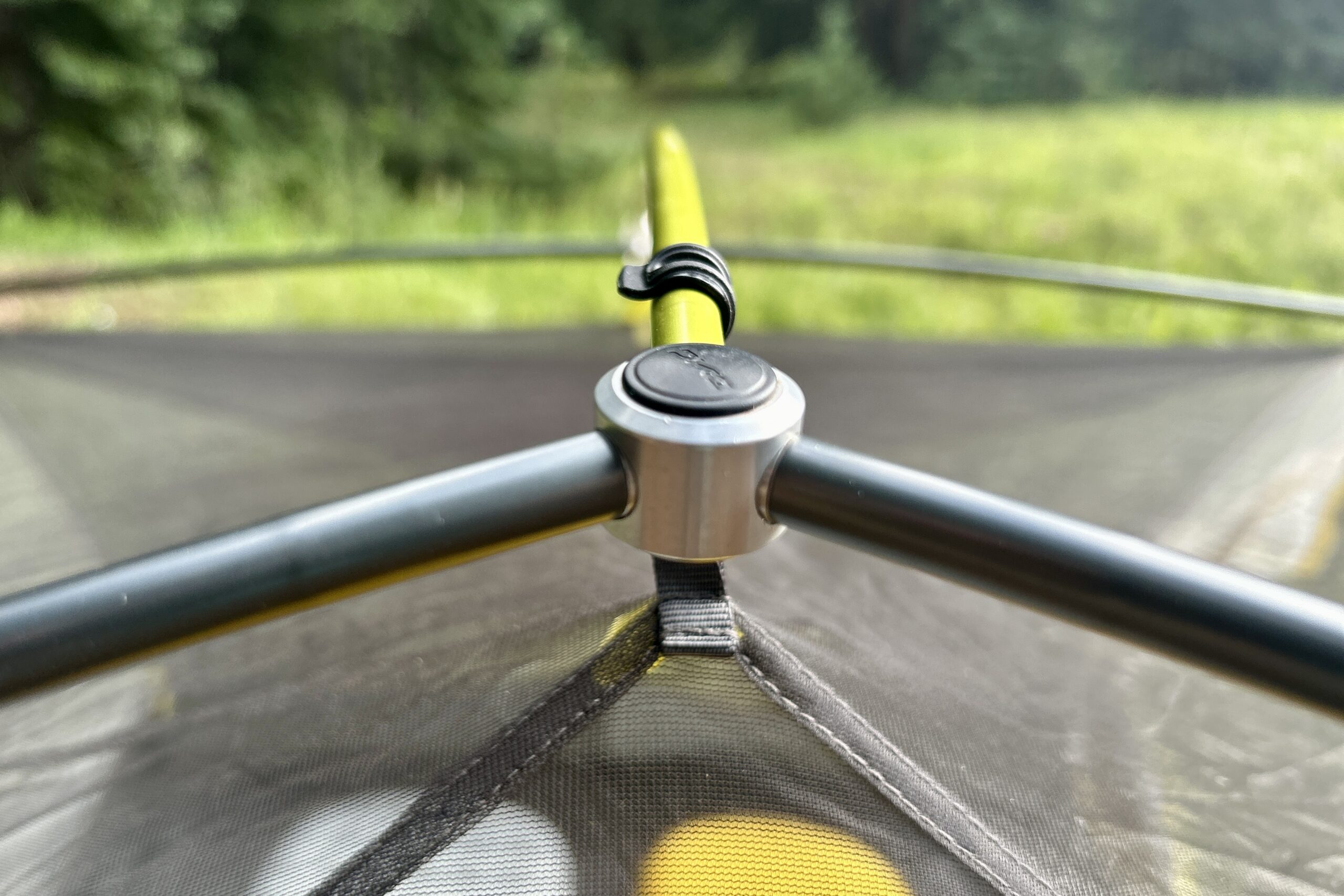 A closeup shot of the poles holding up the top of a tent.