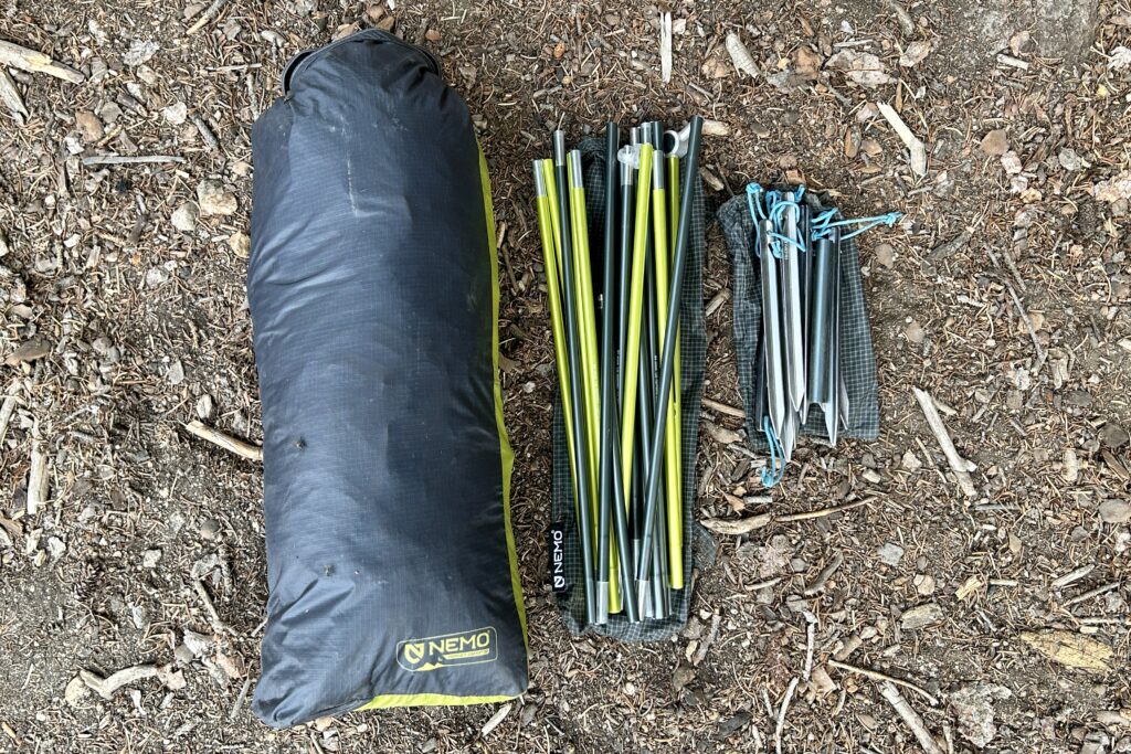 Closeup image of the stuff sack with tent insidek poles, and stakes of the Nemo Hornet 3.