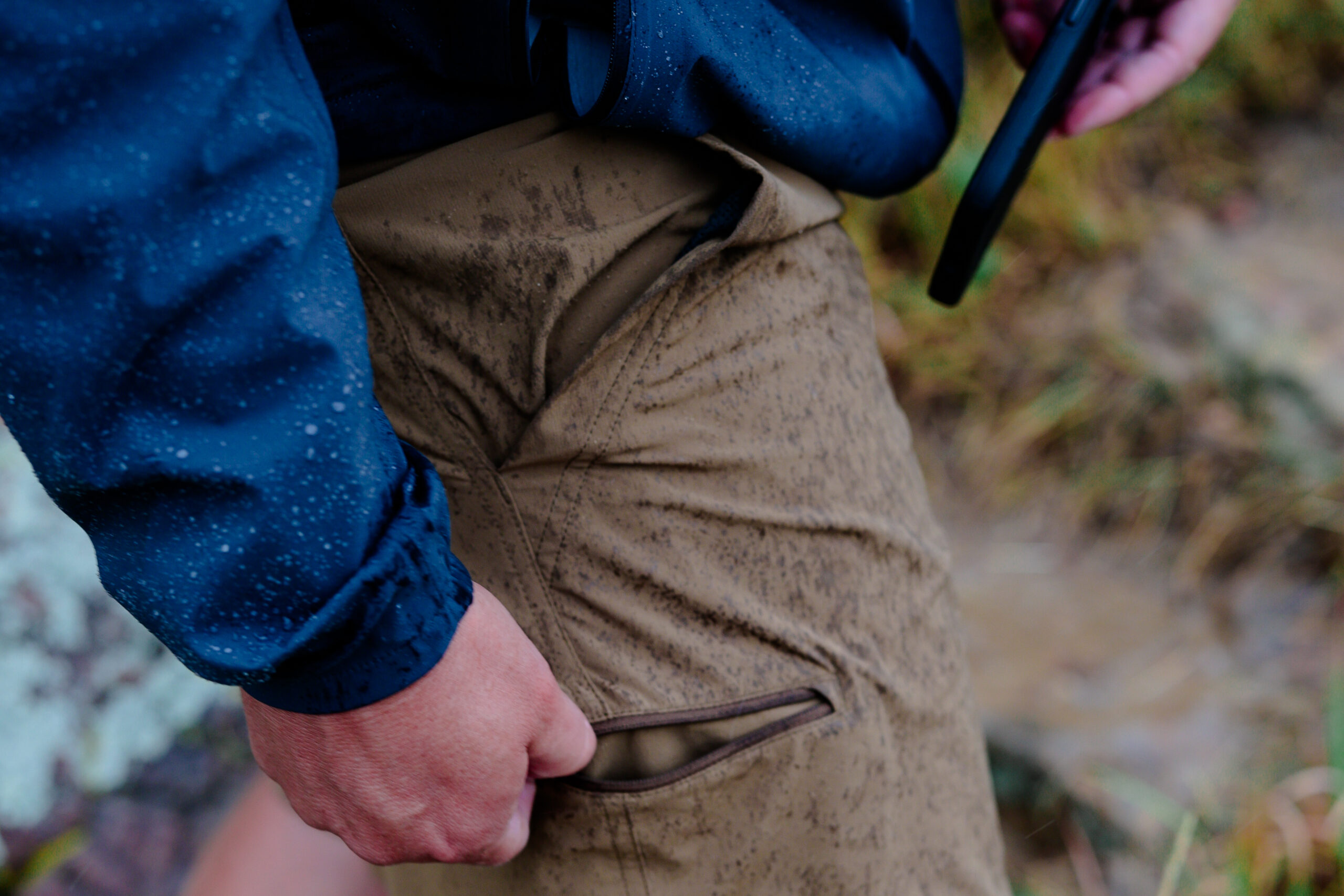 A hand a the side pocket on a pair of shorts