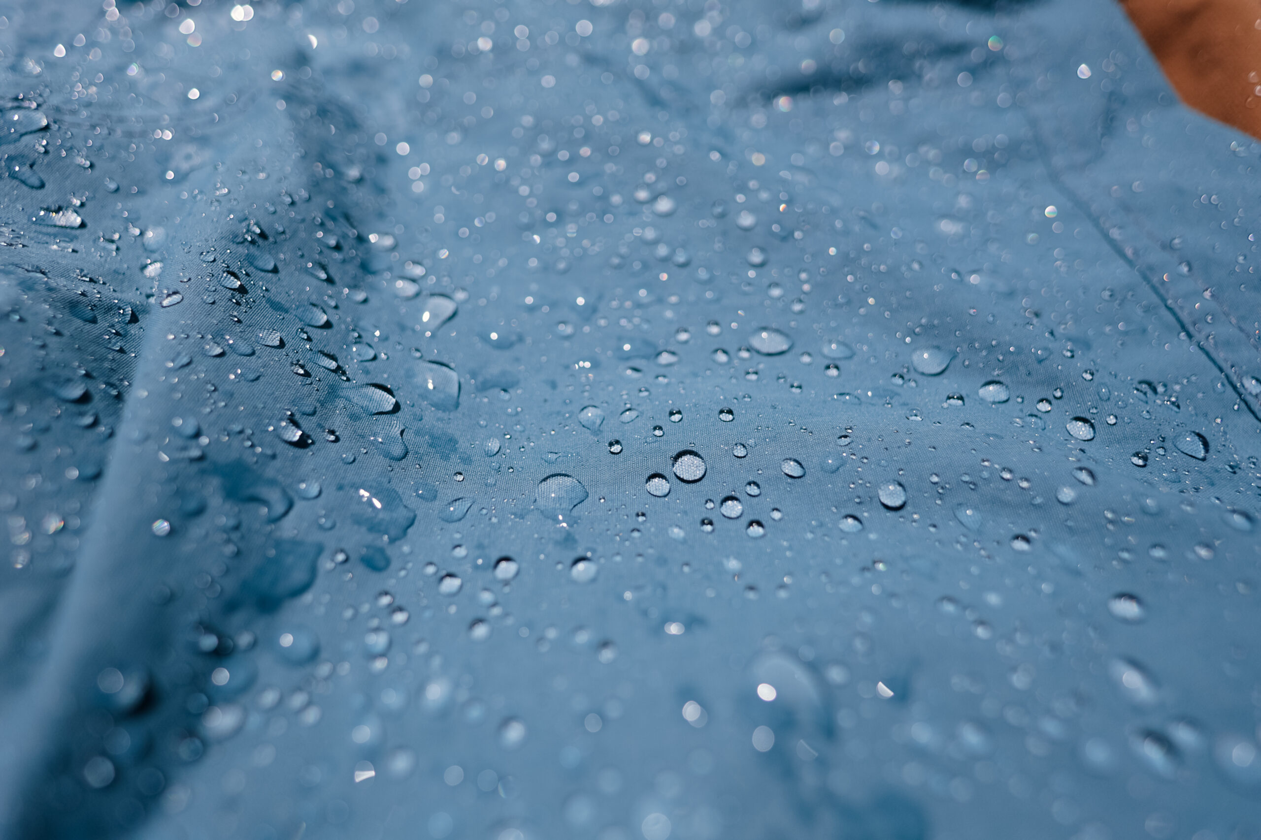 Beads of water close up on hiking shorts.