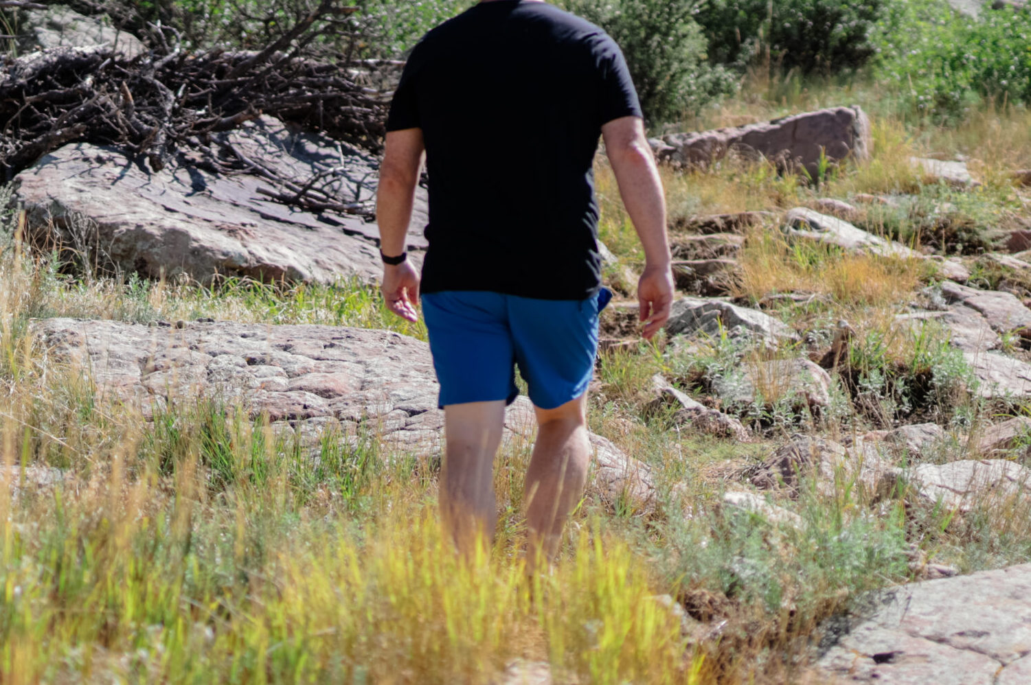 Man hiking up a rocky trail.