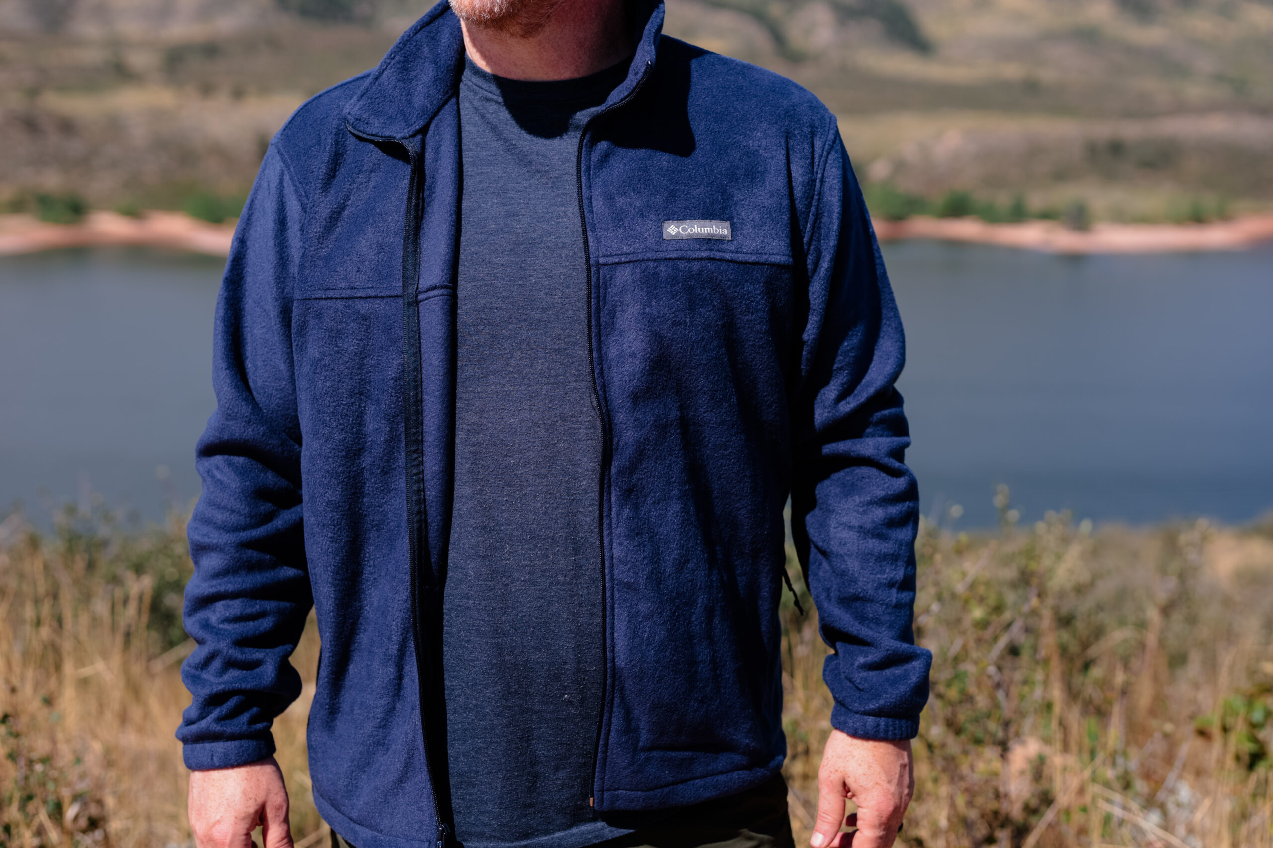 The front of a man wearing a blue fleece.