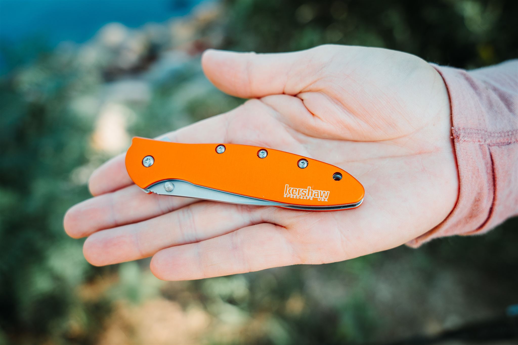 Holding the Kershaw Leek pocket knife in palm of hand to show the size