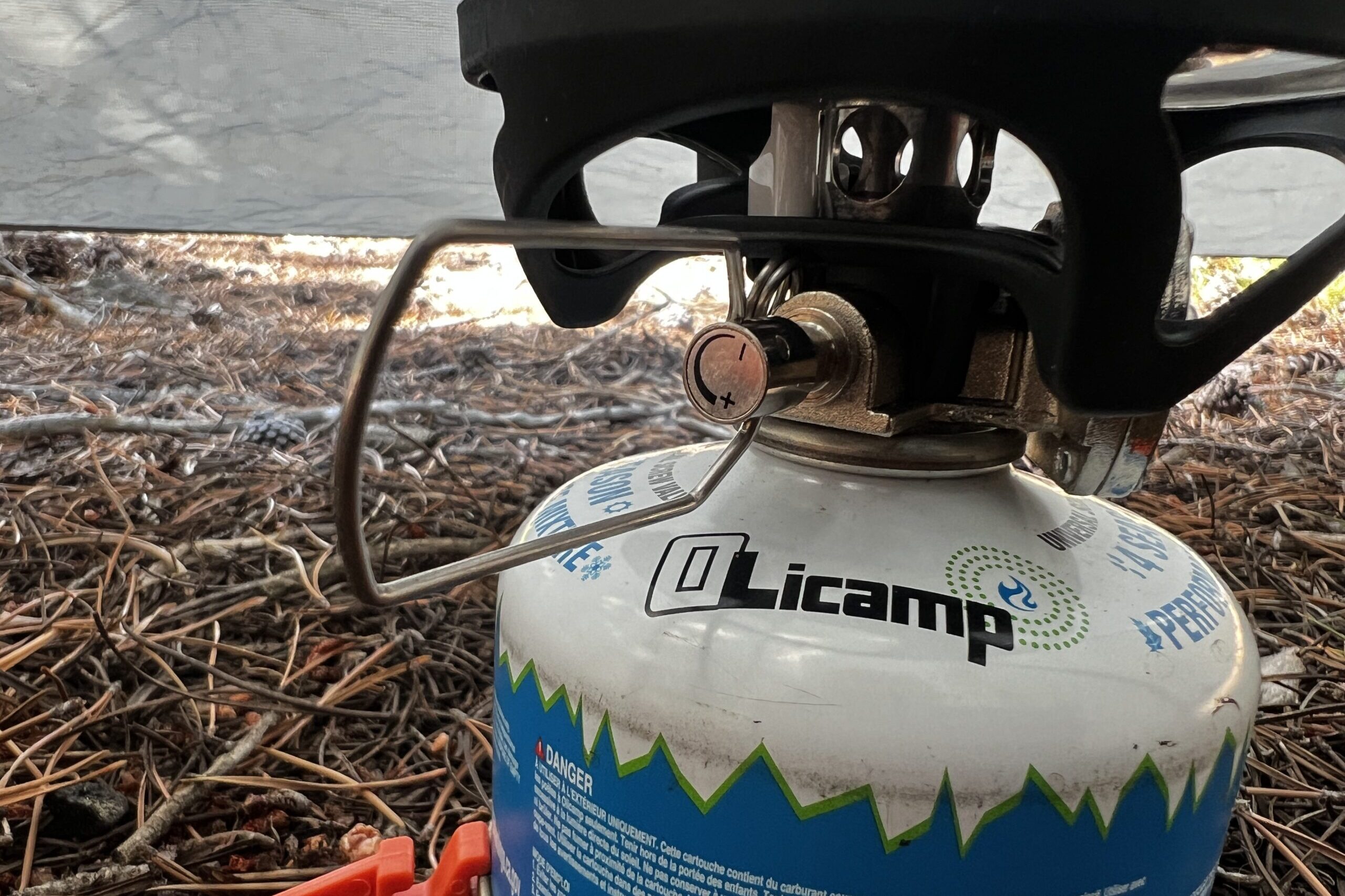 A close up of the valve control knob on the JetBoil MiniMo with fuel canister and burner installed.