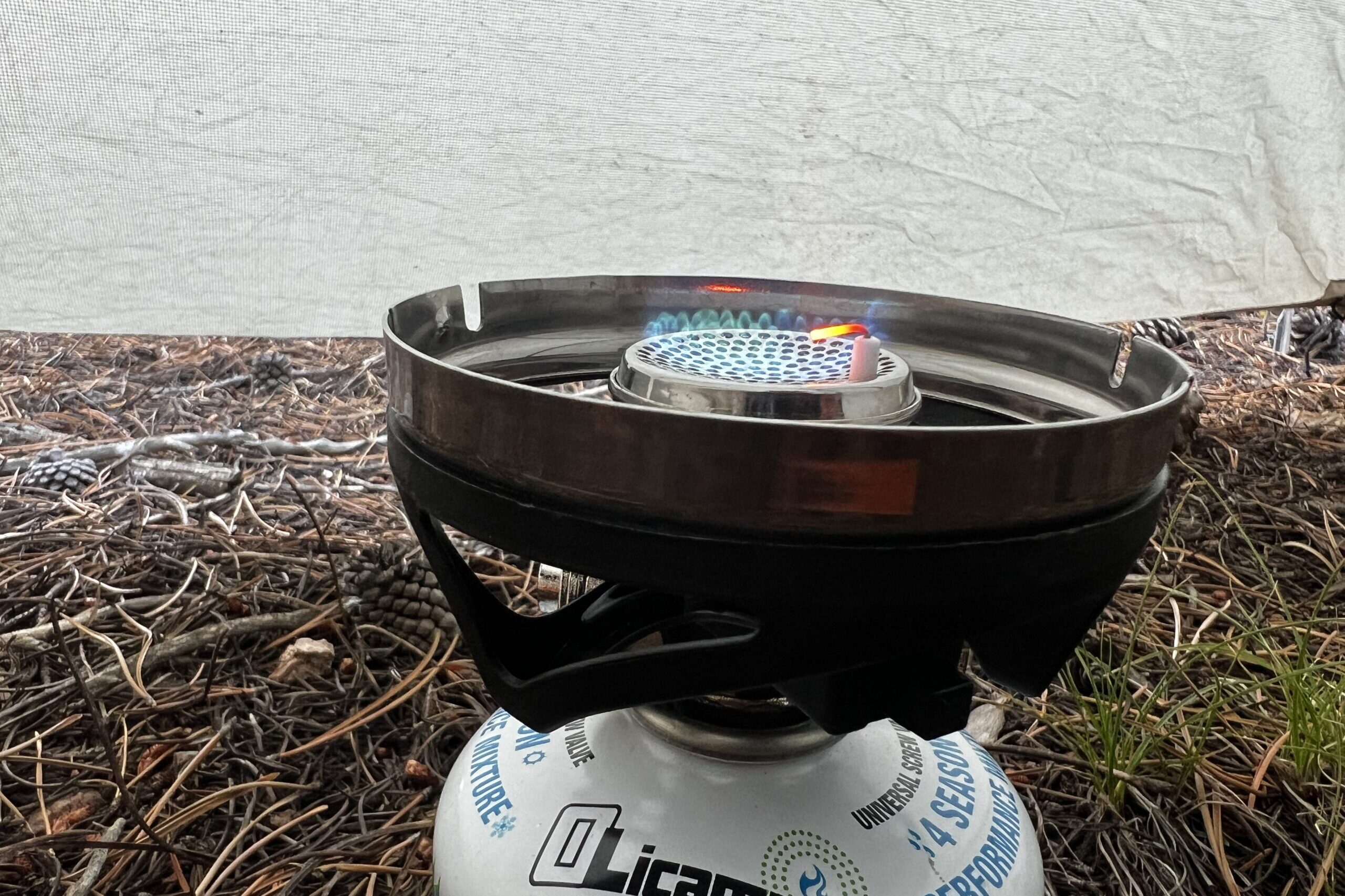 A close up of the flame on the JetBoil Minimo with a tent wall background.