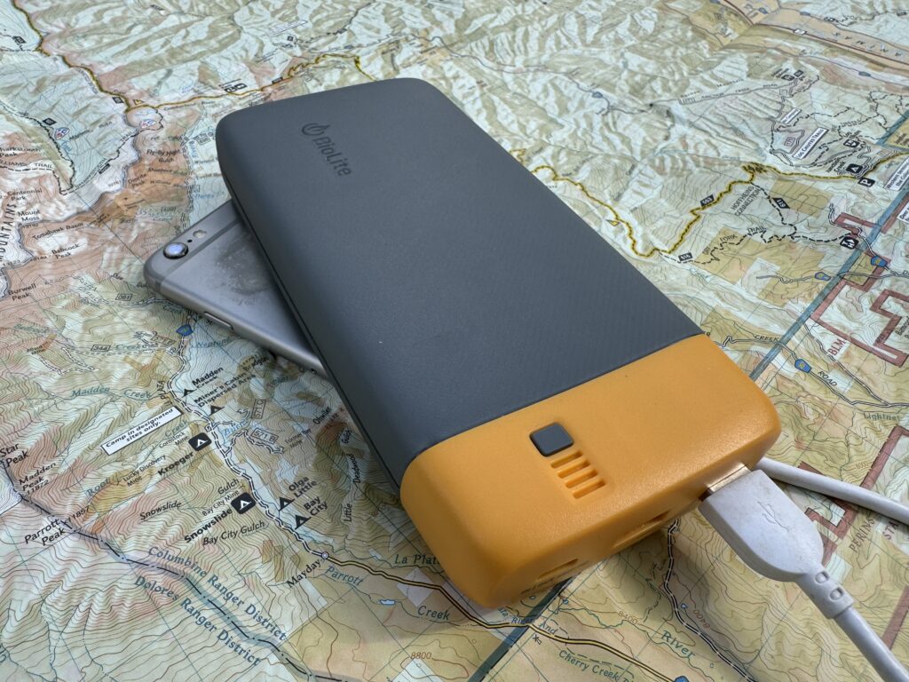 The BioLite power bank and a phone sit on a map.